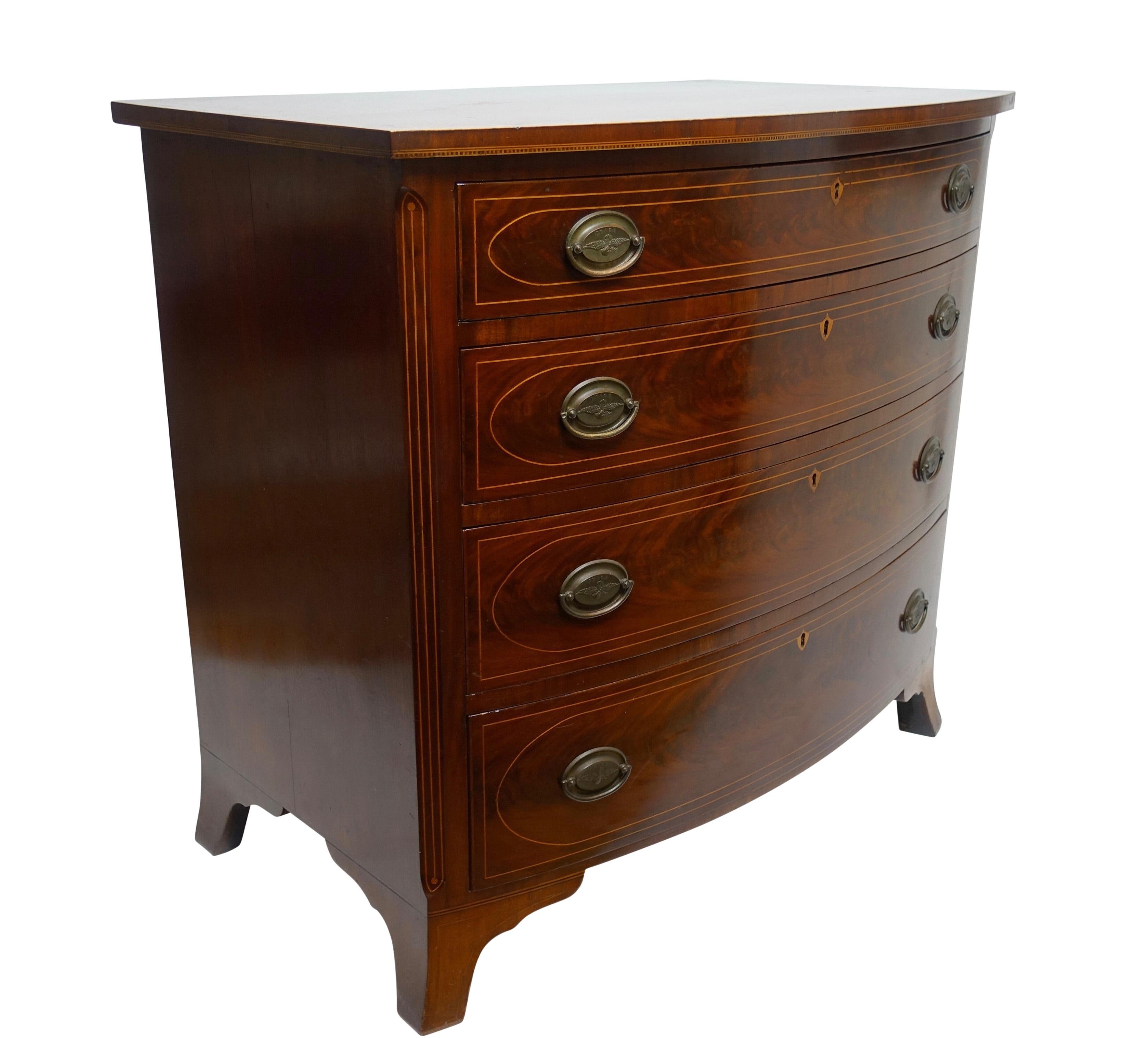 Federal period Mid-Atlantic American bow front mahogany chest of drawers with some very unusual details. Four graduated drawers, crossbanding around a part of the top, satinwood inlaid dental detailing around the bottom edge of the top with string