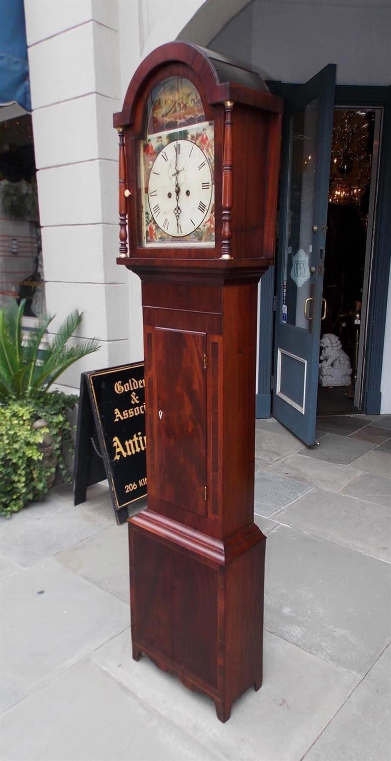 American Federal Mahogany tall case clock with arched bonnet, flanking turned bulbous ringed brass columns, painted face with fox hunting scenes, bone knob and key escutcheon, Kings wood cross banding, satinwood string inlay, and terminating on a