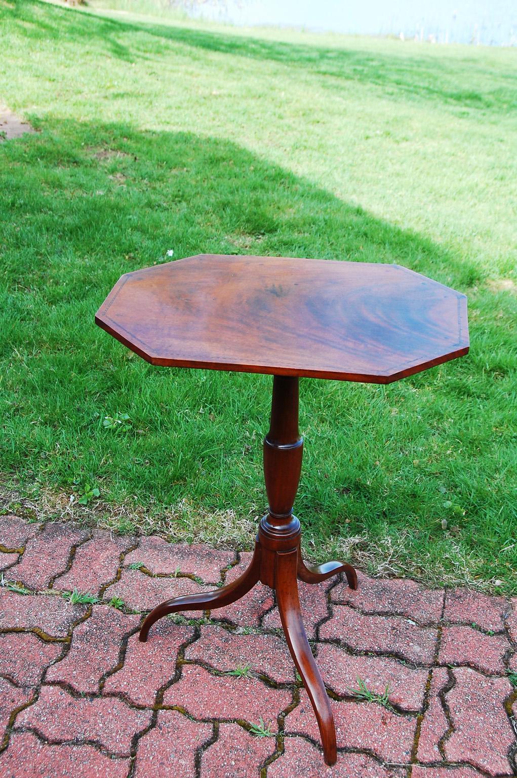 American Federal period Portsmouth, New Hampshire Tripod Candlestand in mahogany with delicate boxwood patterned stringing to the top.. This tilt table has an octagonal top with typical Portsmouth graceful turned urn shaped stem and tripod base. The