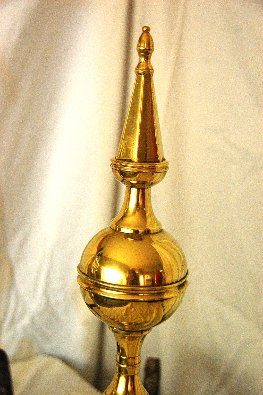 American Federal period brass spire and belted ball top andirons, Impressed Signature:
R. Wittingham N(ew) YORK, seamed, hexagonal spire and column, cabriole legs, ball feet; refurbished iron log carriers, casting flaw on the back surface of the