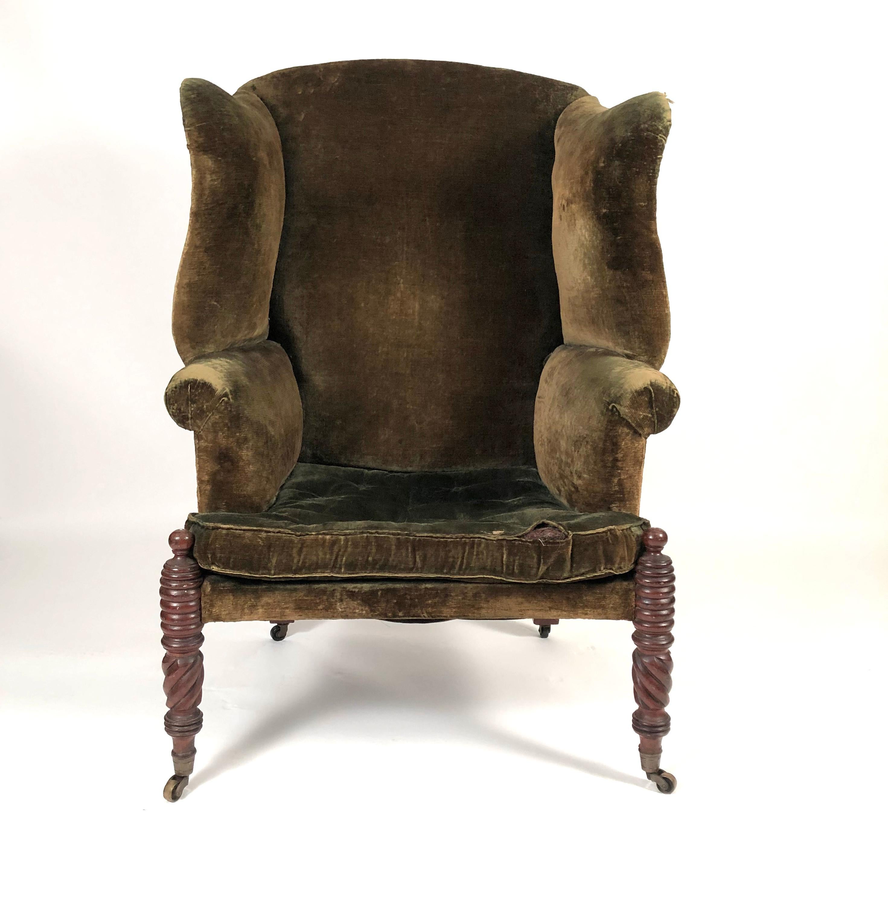 A Federal period wingback chair from Portsmouth, New Hampshire, circa 1810-20, with rope twist carved legs in mahogany, the tops of the two front legs. Each inlaid with a bone dot. This chair has a wonderfully bold form with beautifully carved legs.
