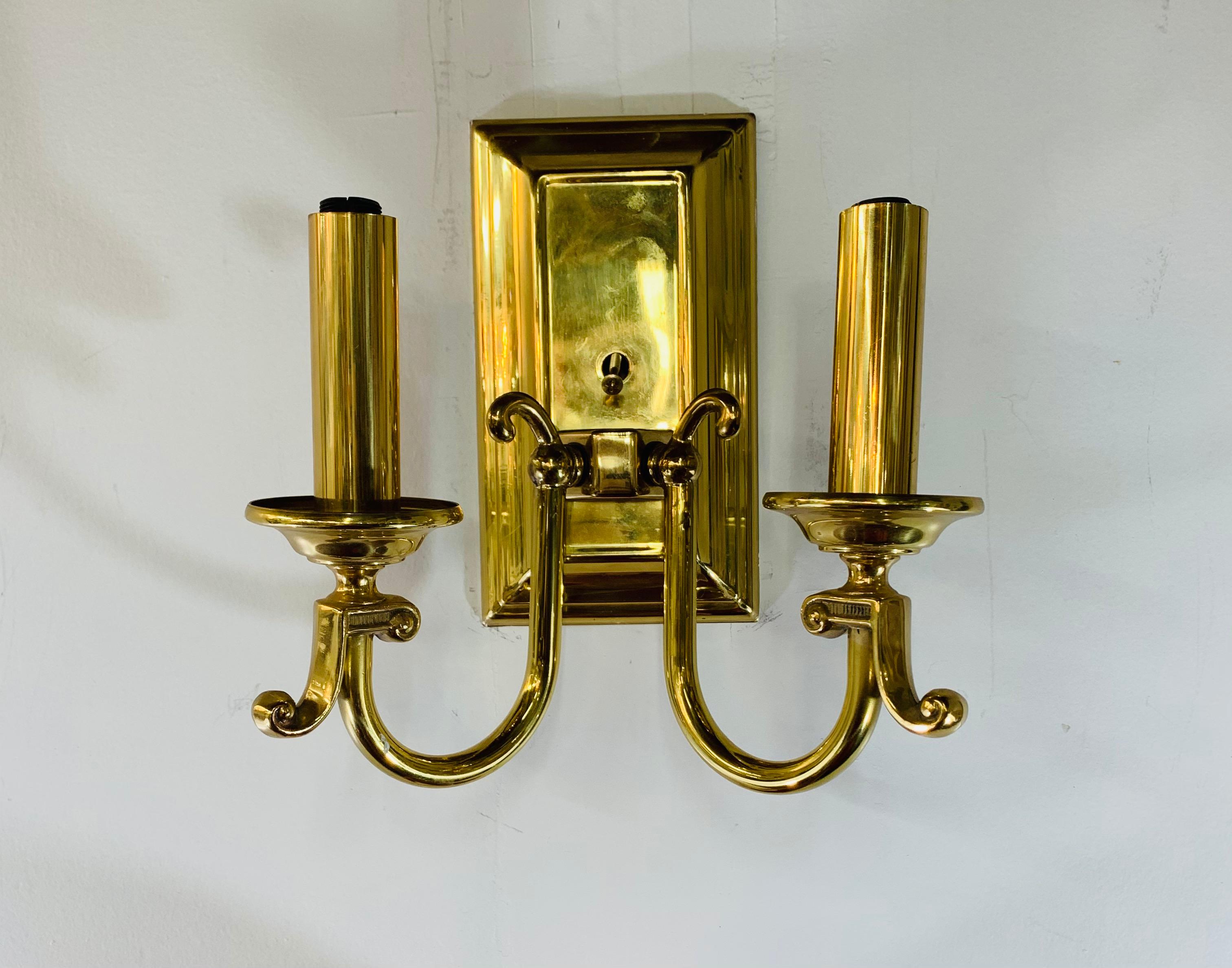 A quality and fashionable set of four brass American Federal style wall sconces. Each sconce featuring two candelabras arms ending with a scroll.

A delightful set to decorate and add light to your hallway or staircase or any room.