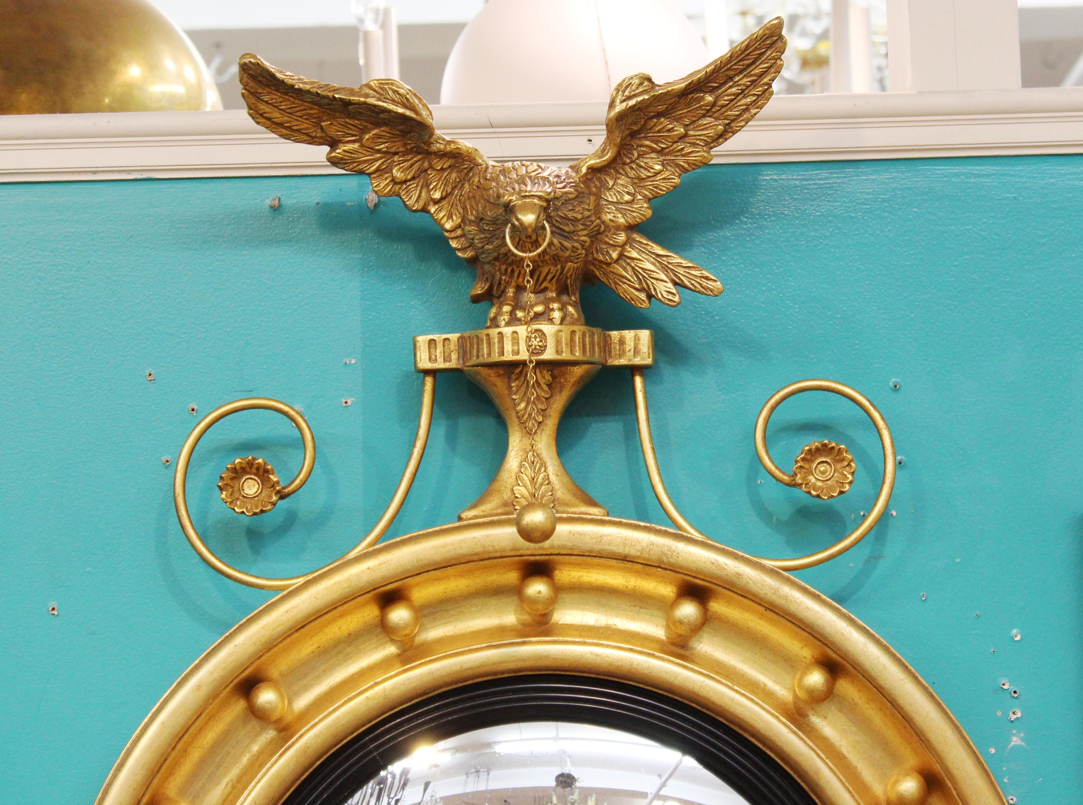 American federal style convex giltwood girandole wall mirror with carved eagle.