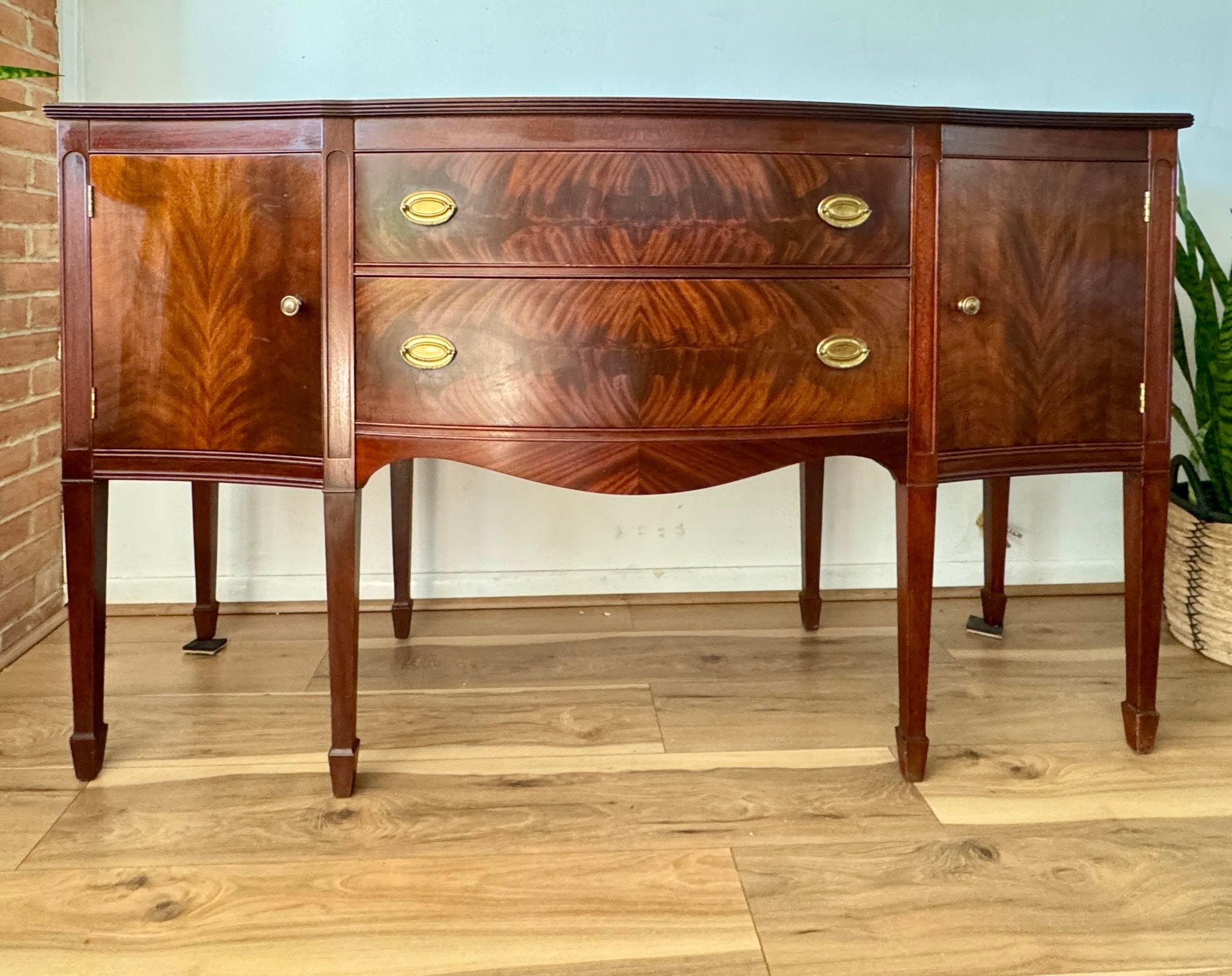 Sheraton-style mahogany sideboard server with spacious storage features. This elegant piece showcases two expansive drawers and two large cabinets, providing ample storage space.
