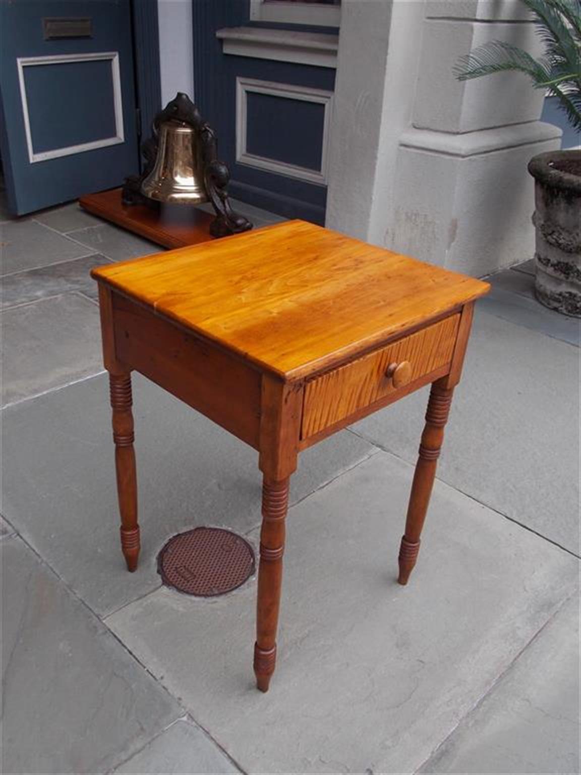 American Federal tiger maple one drawer stand with original wood knob, turned bulbous ringed legs, and the original pointed feet. Secondary wood consist of poplar, Early 19th century.