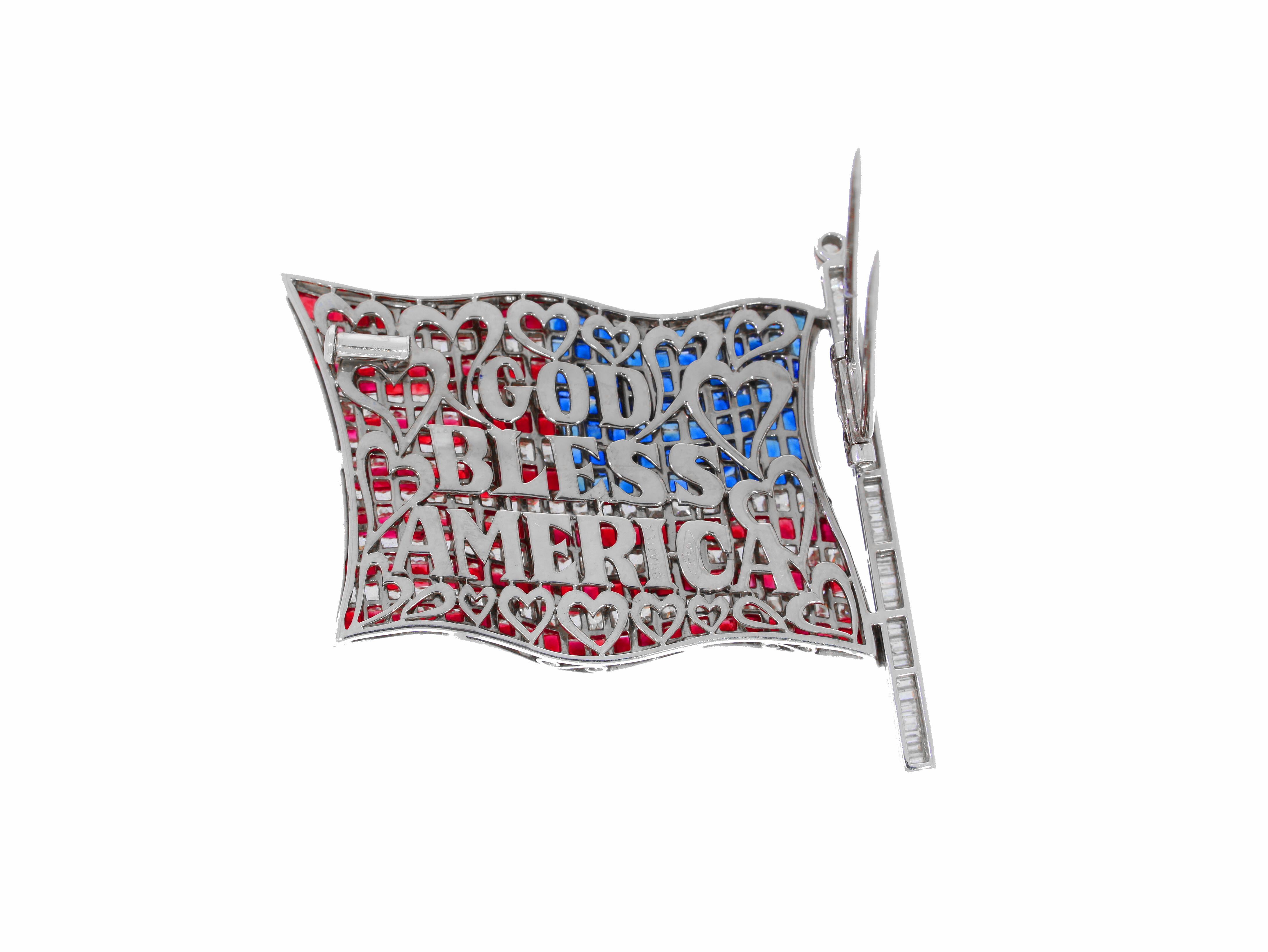 This stunning, patriotic American flag brooch is set with natural rubies, sapphires and diamonds. The historic quote, 