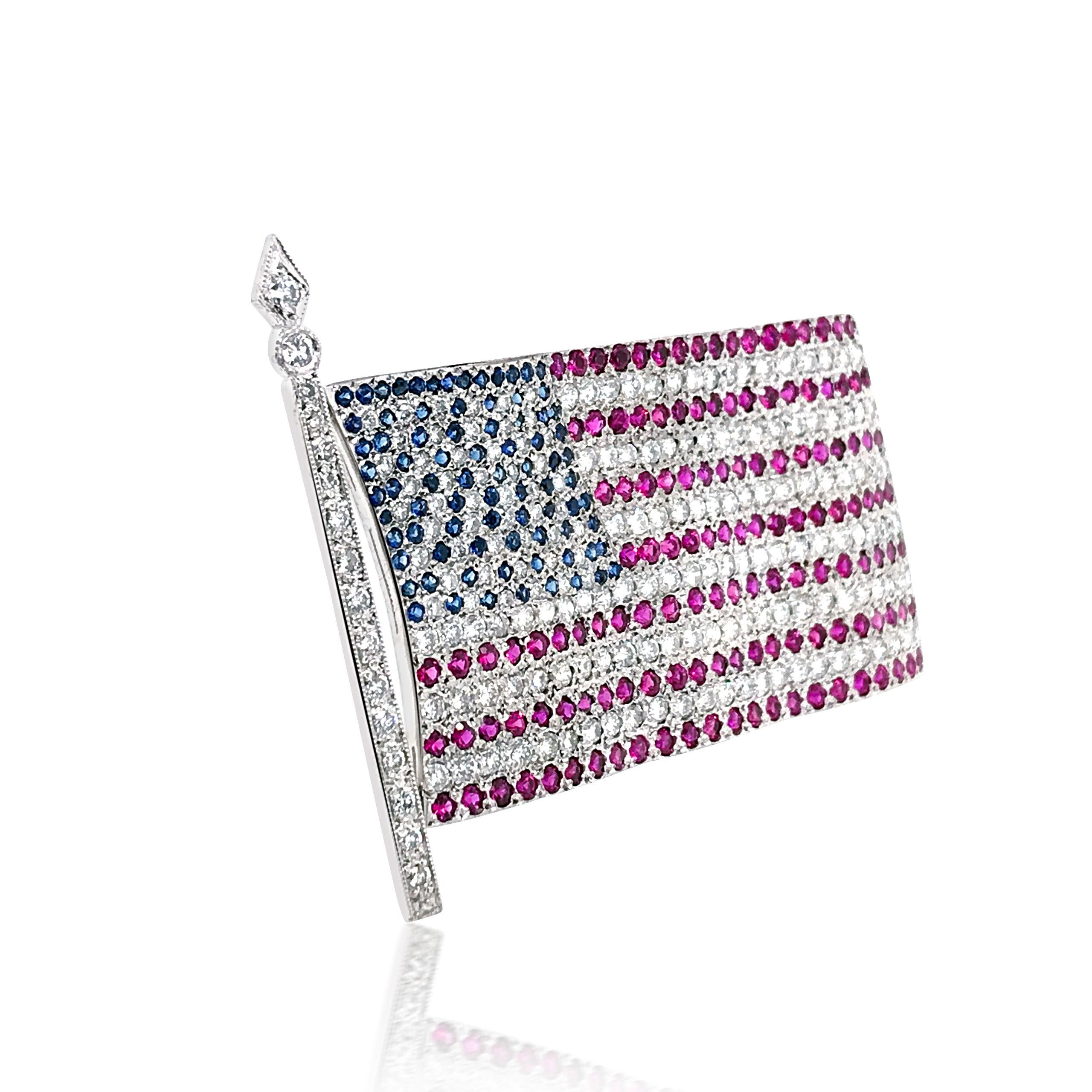 This American flag brooch features about 178 round diamonds size ranging from 0.025 to 0.01cts cumulatively weighing approx. 4.2cts. The stripes on the flag contain 135 round rubies cumulatively weighing approx. 4.1ct, and the stars on the flag