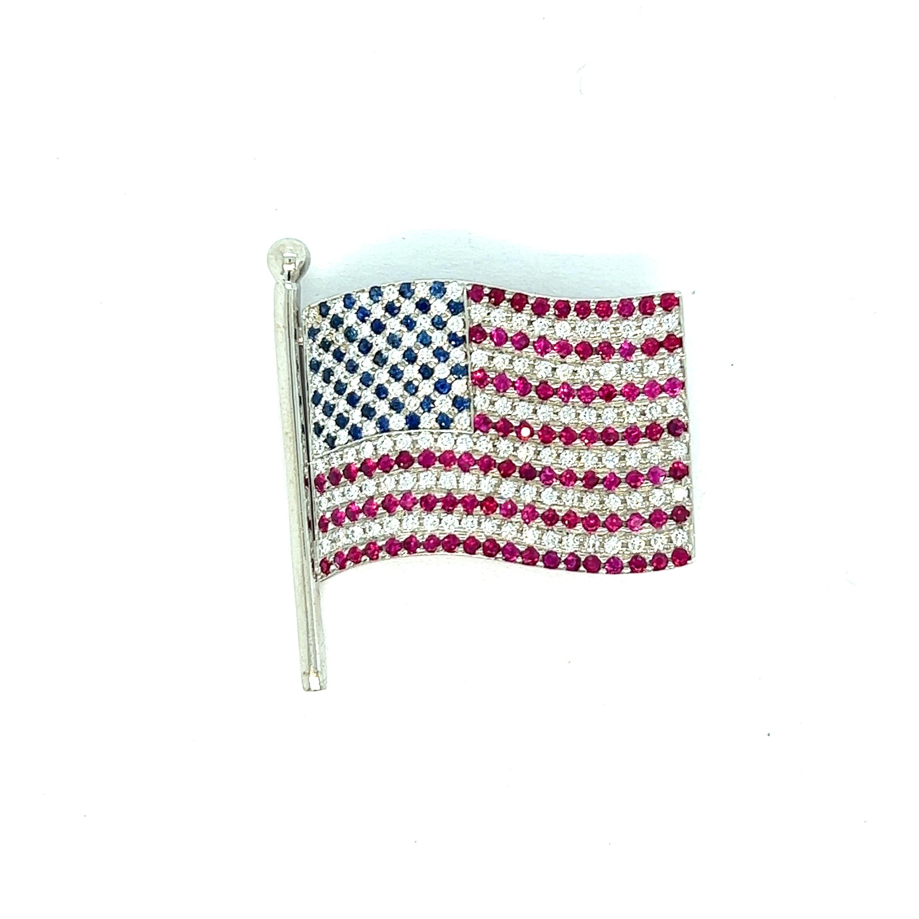 American flag pin brooch

Round-cut diamonds, sapphires, and rubies set on 18 karat white gold; marked Carelle, 750

Size: width 3 cm, length 3.5 cm
Total weight: 13.4 grams