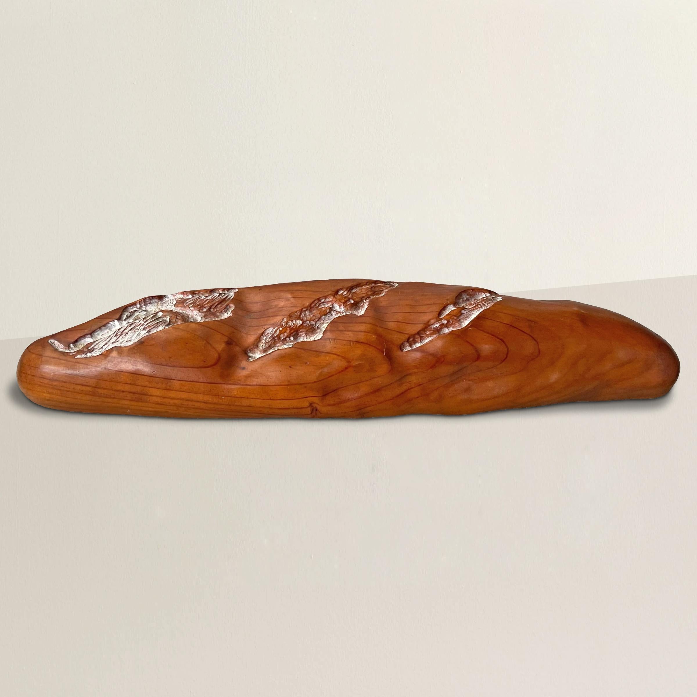 Celebrate the whimsical charm of American Folk Art with this hand-carved pine sculpture resembling a baguette, a delightful fusion of creativity and playfulness. Crafted with meticulous detail, the faux slits on top mimic the expansion of bread