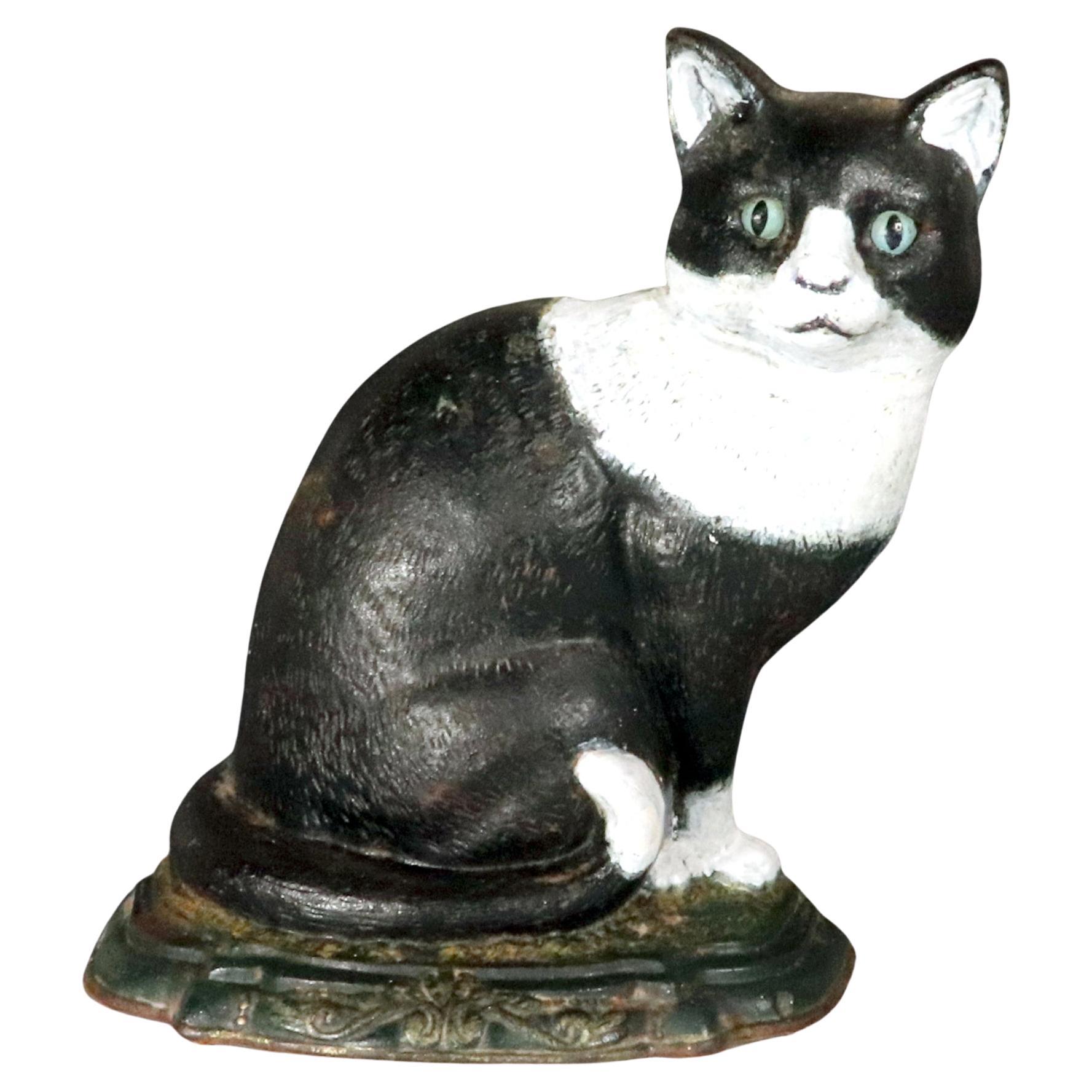 American Folk Art Door Stop in the Form of a Sitting Cast Iron Tuxedo Cat For Sale