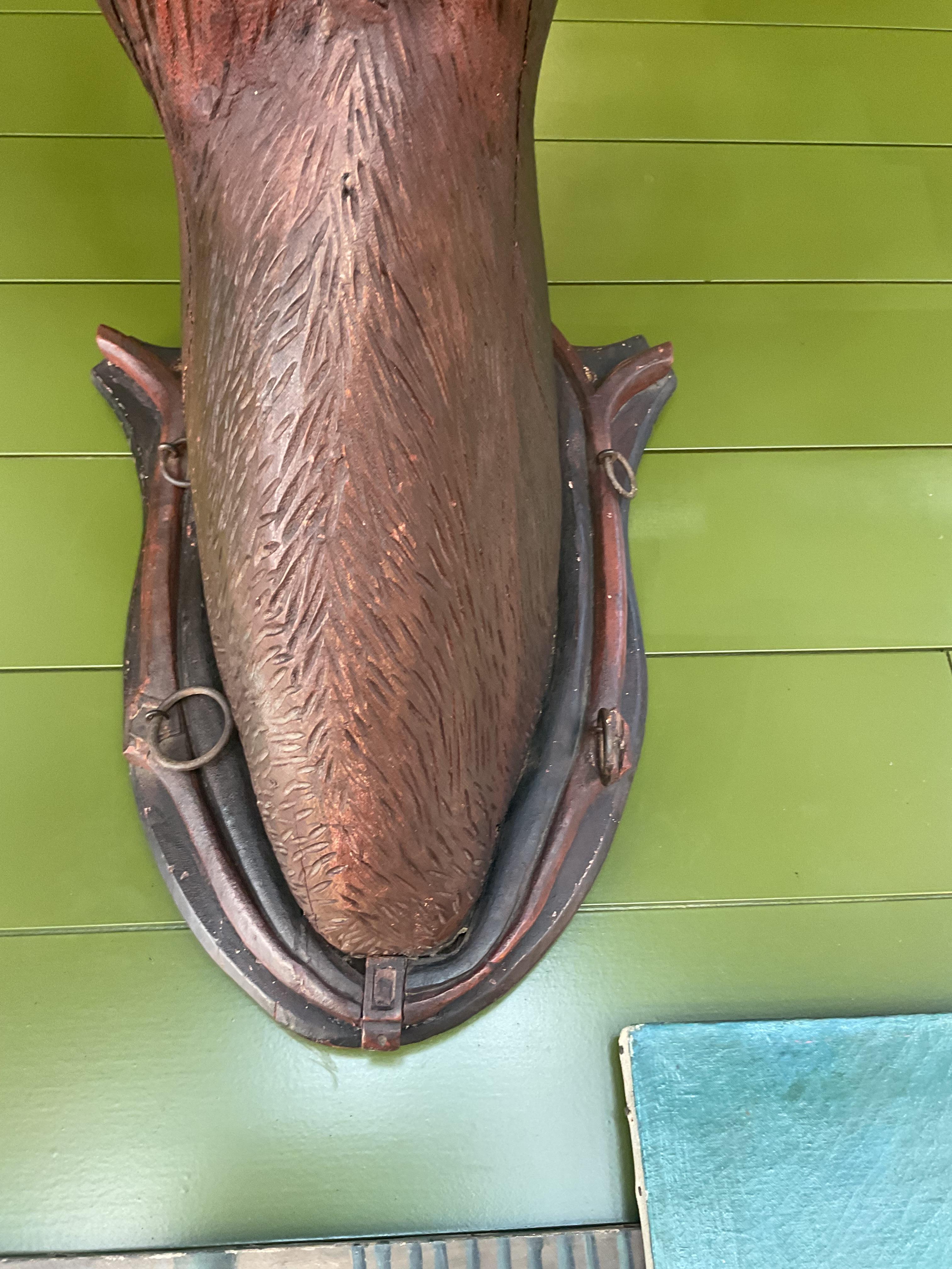An exceptional and rare example of 19th-century American carved folk art, this monumental elk head is mounted on a striking polychrome shield plaque. Dating to circa 1890 and originating from a historic Maine lodge, this piece exemplifies the