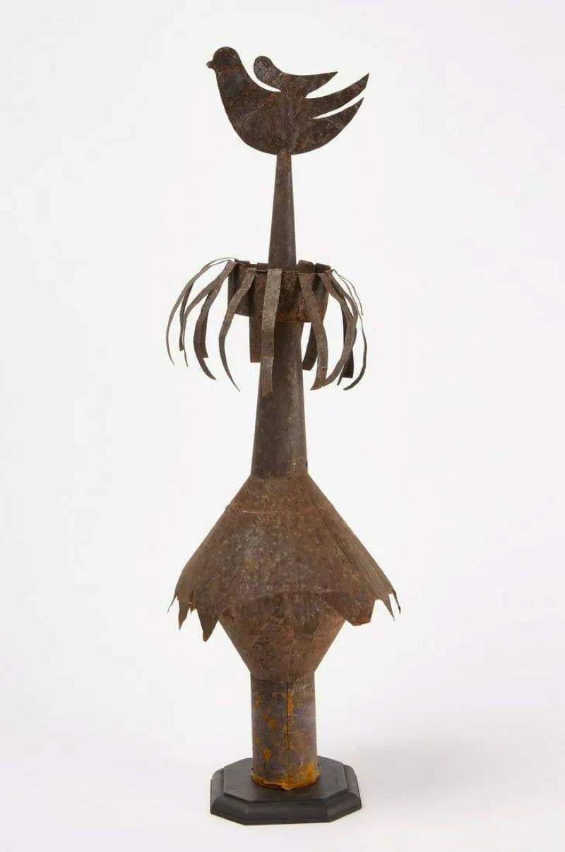 An American folk-art tin rooftop finial with a dove on top, circa 1900 or earlier, rusted finish.