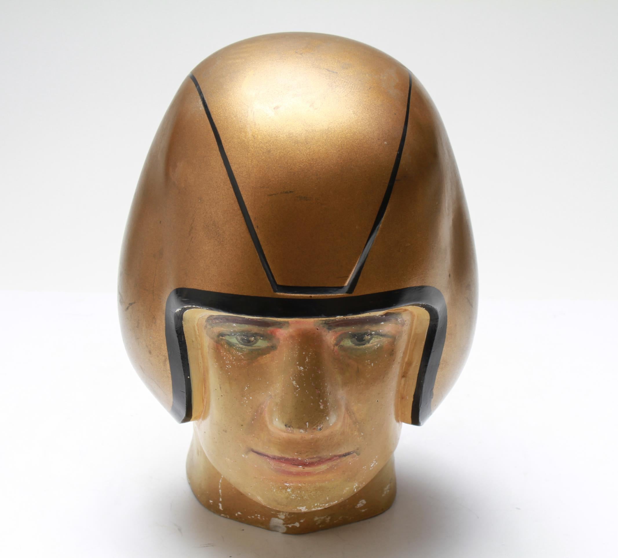 American Folk Art football player bust in composite material, wearing a gold-tone helmet. The piece is in good vintage condition and was made in the mid-20th century.
