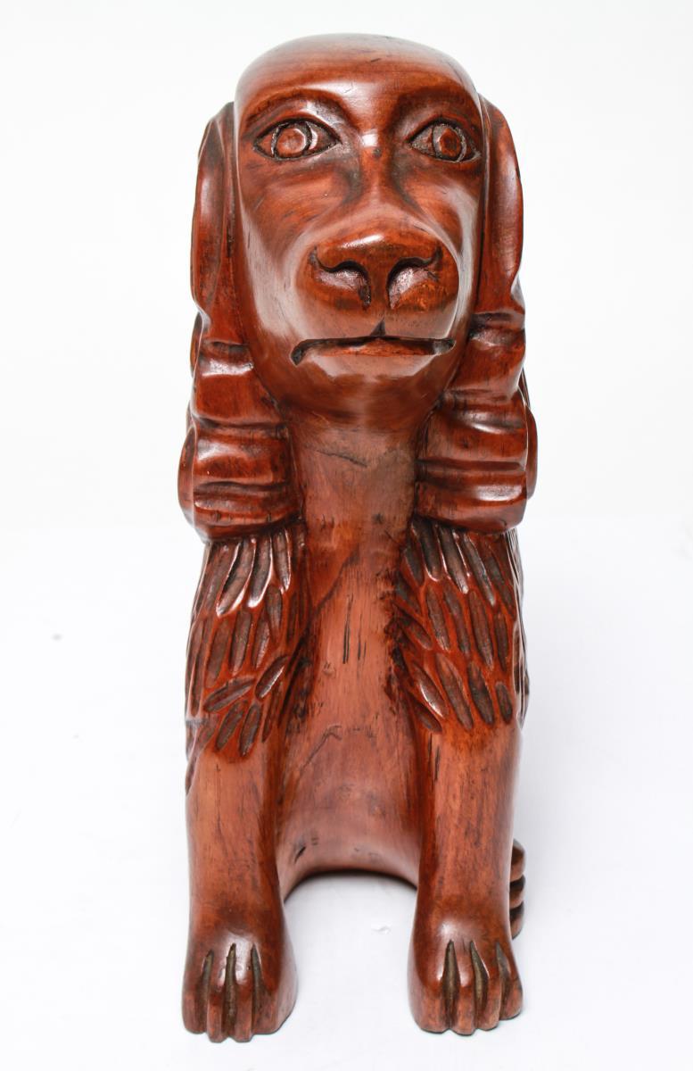 American Folk Art hand carved seated cocker spaniel dog sculpture, with the underside incised and dated 'T. Plummer / Ja. WI / 1975'. Some shrinkage cracks to the wood.