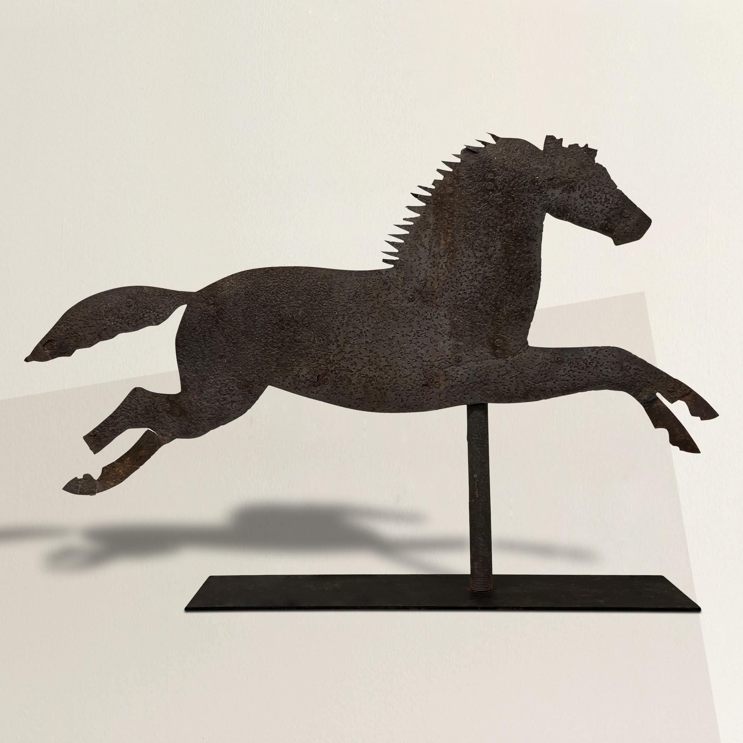 A rather large late 19th/early 20th century American Folk Art cut steel weathervane with a leaping horse silhouette mounted on a steel pipe, and a custom steel mount.