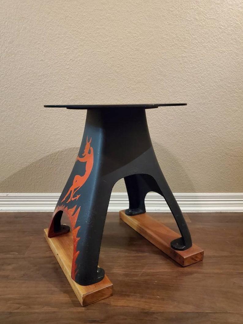 A vintage American Folk Art iron anvil stand (use as side table - display pedestal - accent stand). This unique one-of-a-kind example having a circular platform top, pyramid shape with large open arches, painted matte black, featuring a hand painted