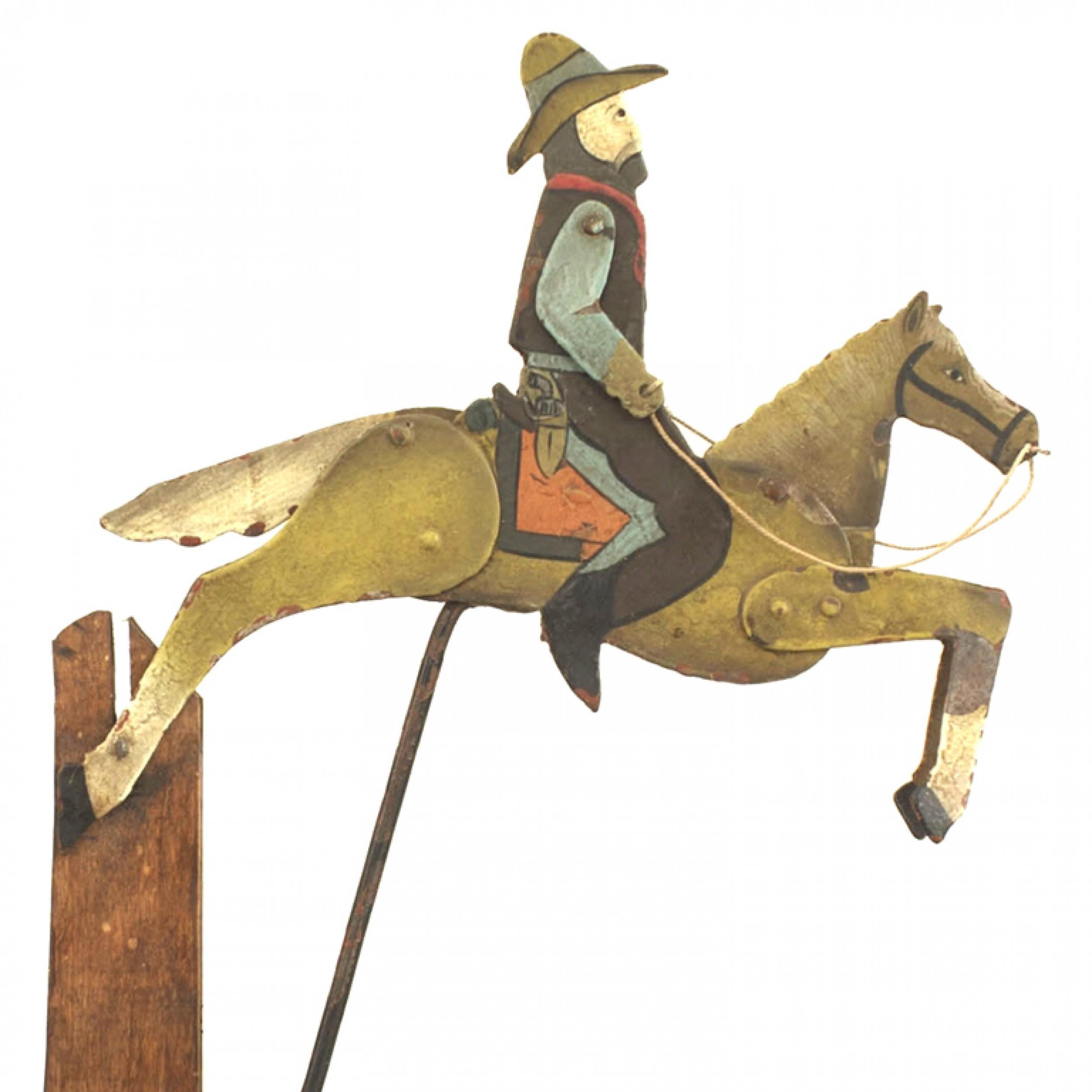 American Country (19/20th Cent) Folk Art toy of a painted and decorated metal cowboy on a horse with moving parts mounted on an balance beam.