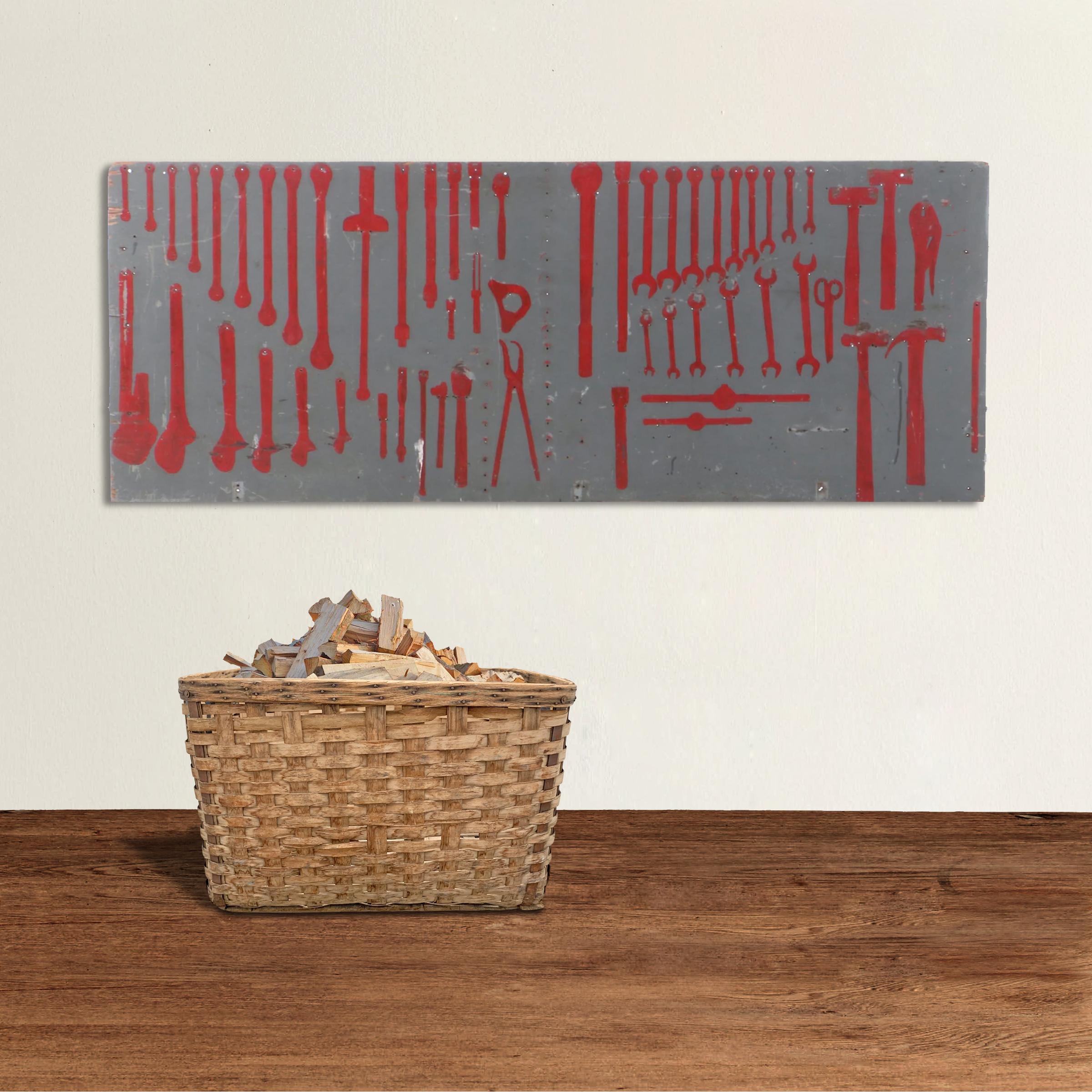 A whimsical and quirky mid-20th century American Folk Art gray and red painted tool board from a workshop originally used to organize tools, but now it makes the coolest wall hung art piece.