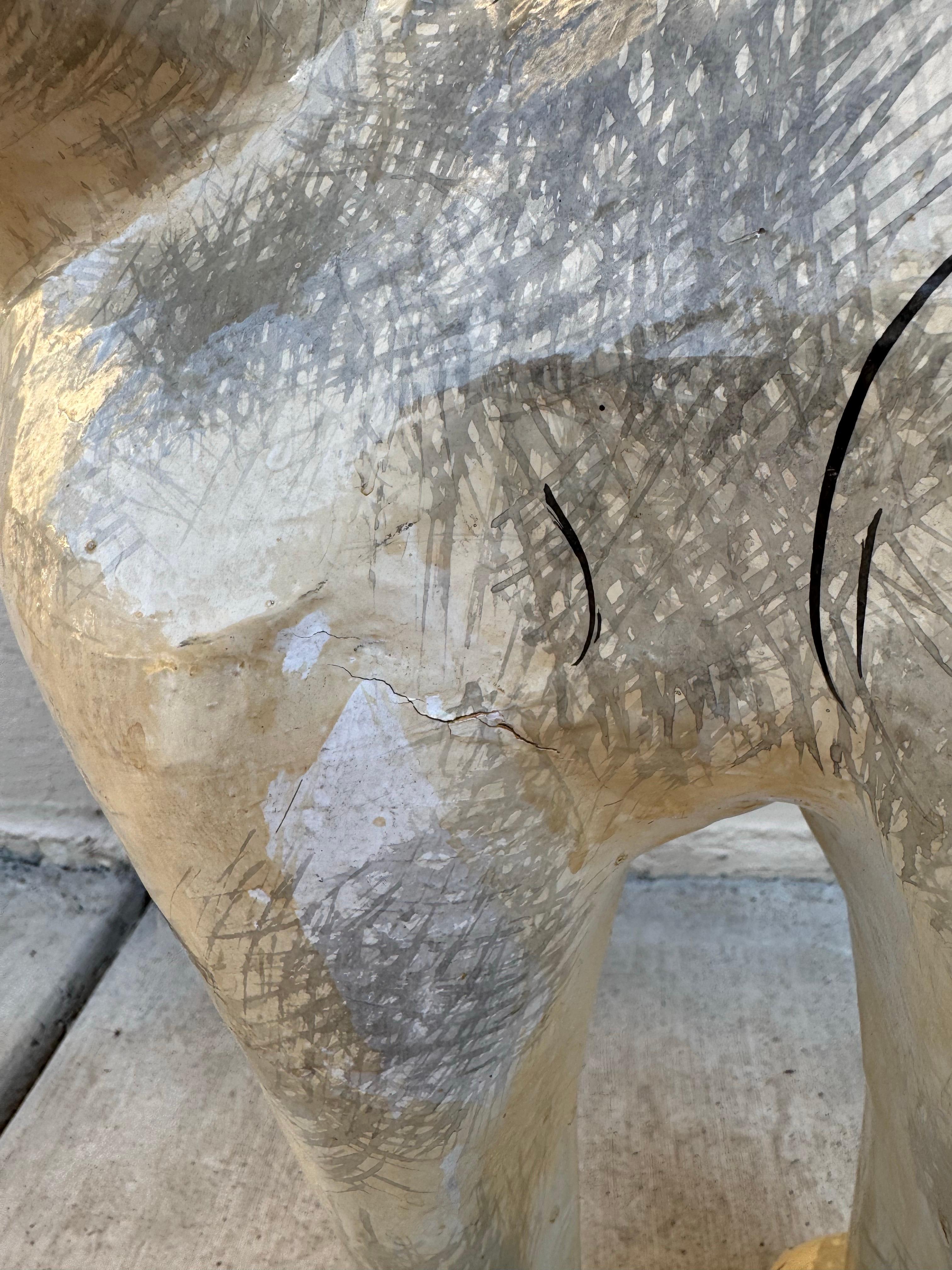 This charming American Folk Art paper mâché cat sculpture has a wonderful presence and personality. Its whimsical form, upright stance, and curled tail give it character, while the hand-painted details—subtle gray shading, expressive yellow eyes,
