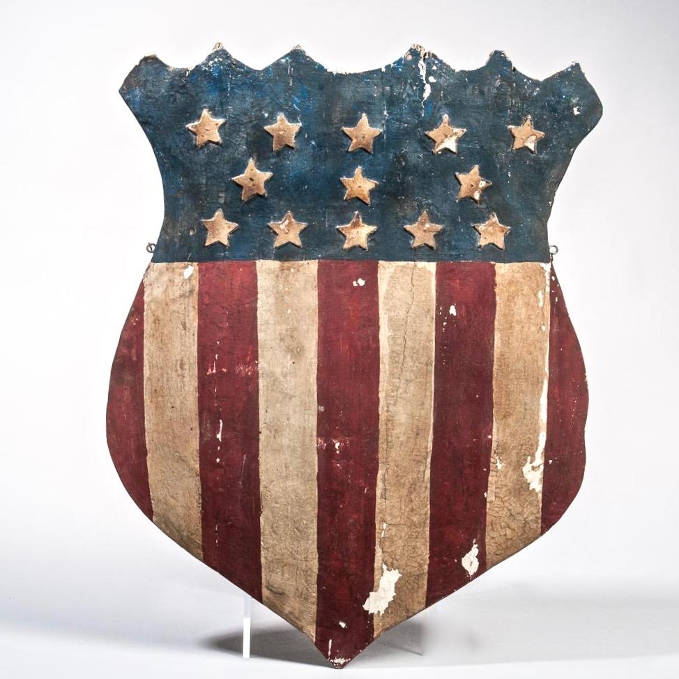 red white and blue flag with shield