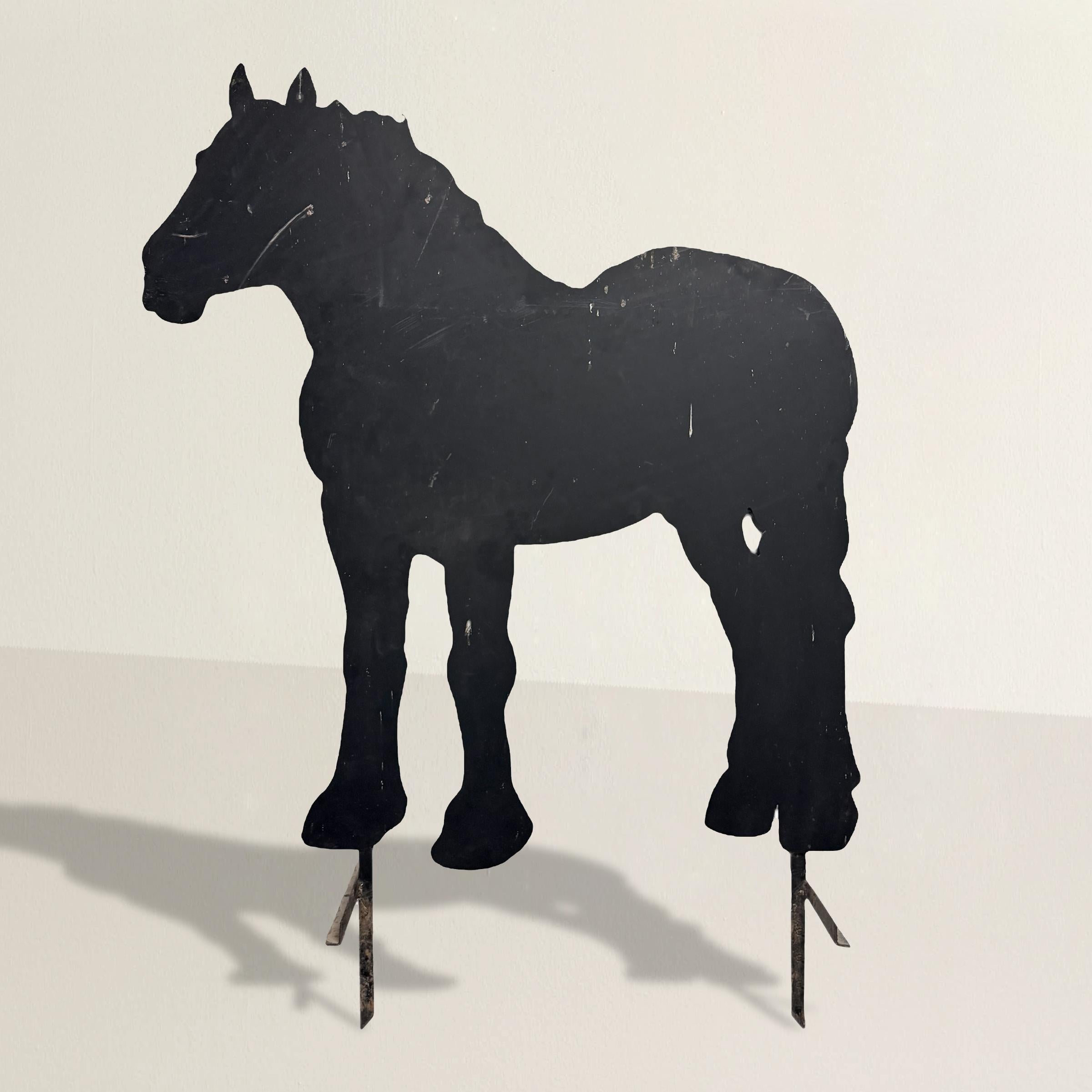 Taillée dans une seule feuille d'acier massif de ⅜ pouces, cette silhouette de cheval de trait debout, datant du XXe siècle, est empreinte de l'autorité tranquille de l'artisanat rural. Découvert dans une vieille grange du Wisconsin, il se tenait