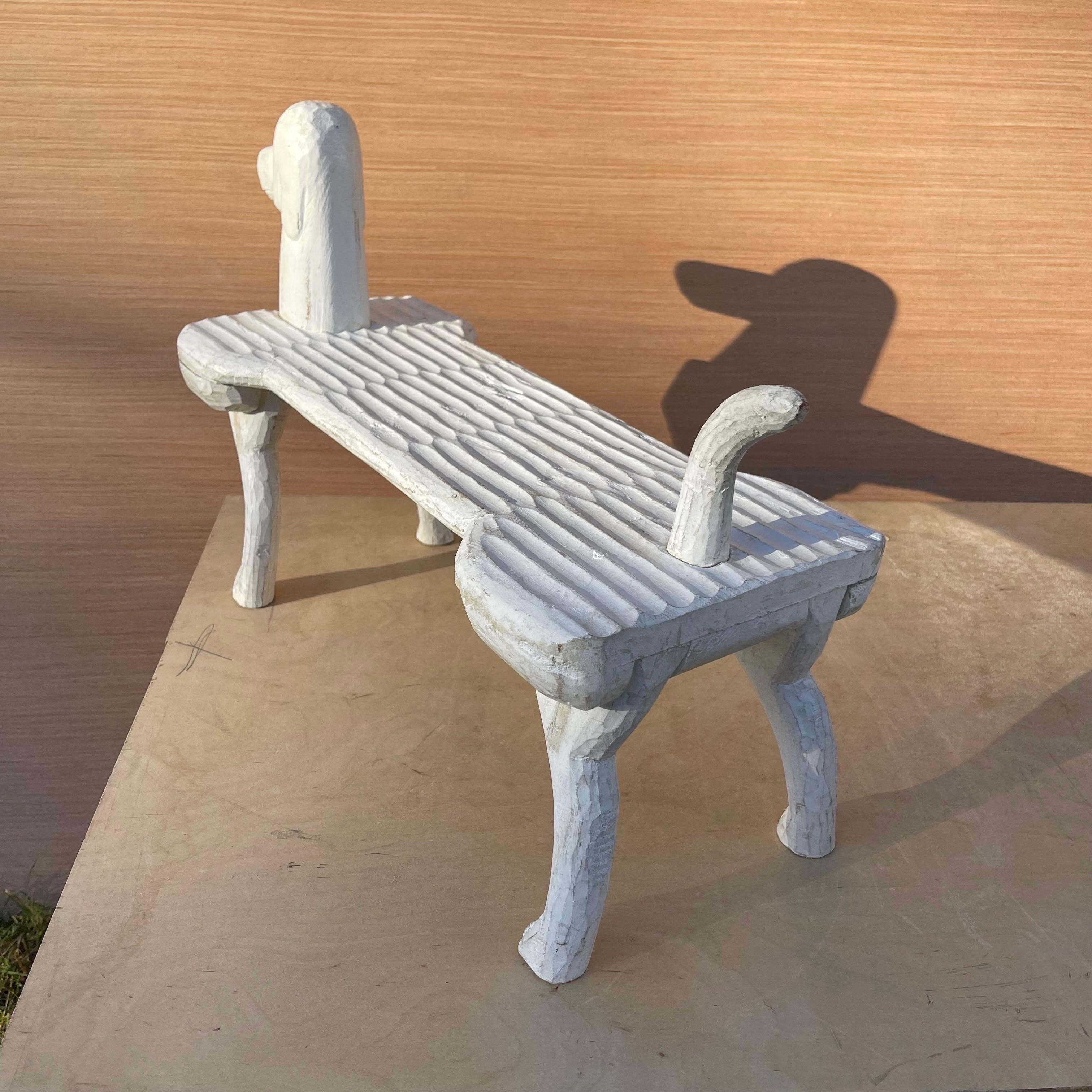 Whimsical dog-form footstool, carved out of wood.