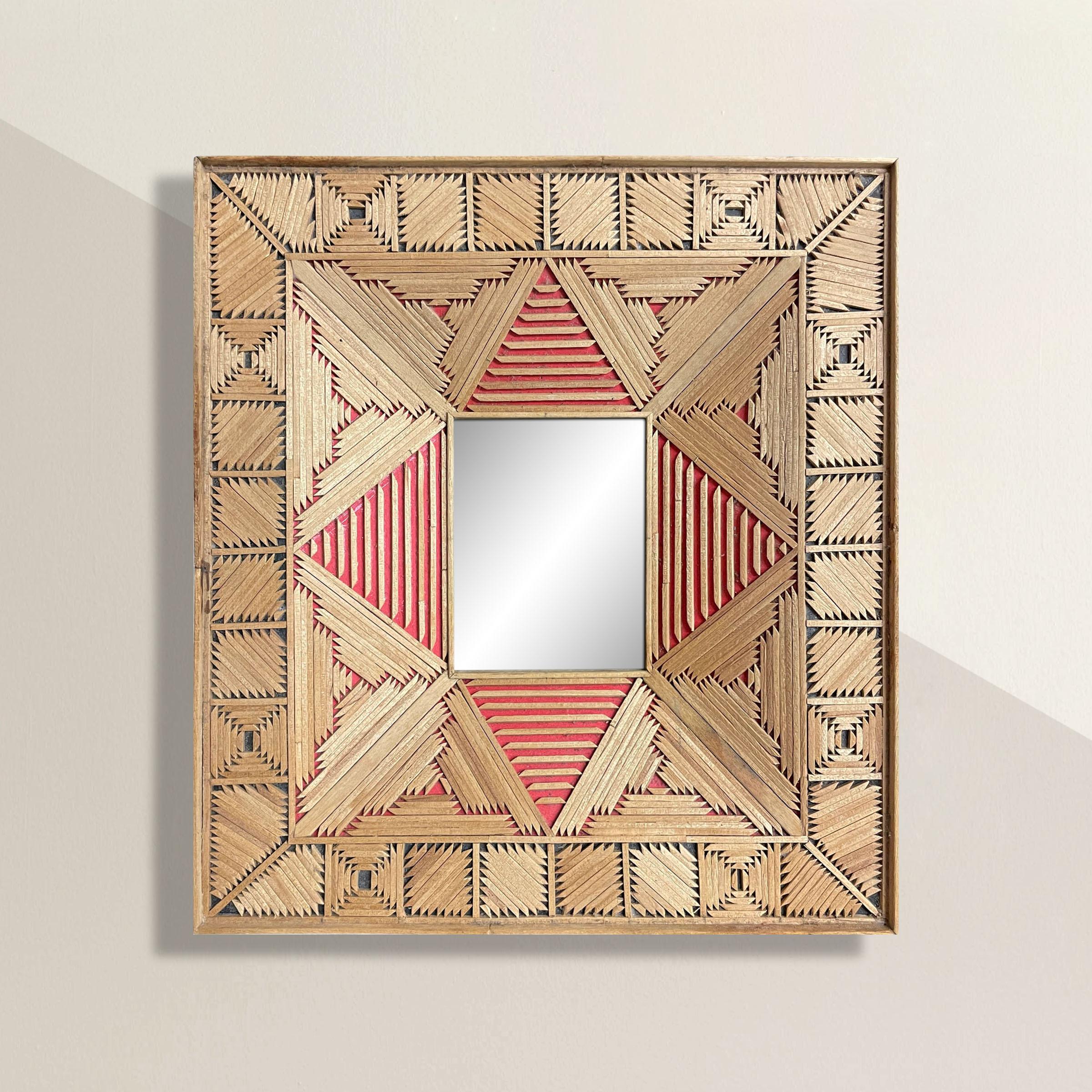 The most charming 20th century American Folk Art mirror with a frame made from thousands of toothpicks, arranged into geometric patterns, and backed with rd and black papers.