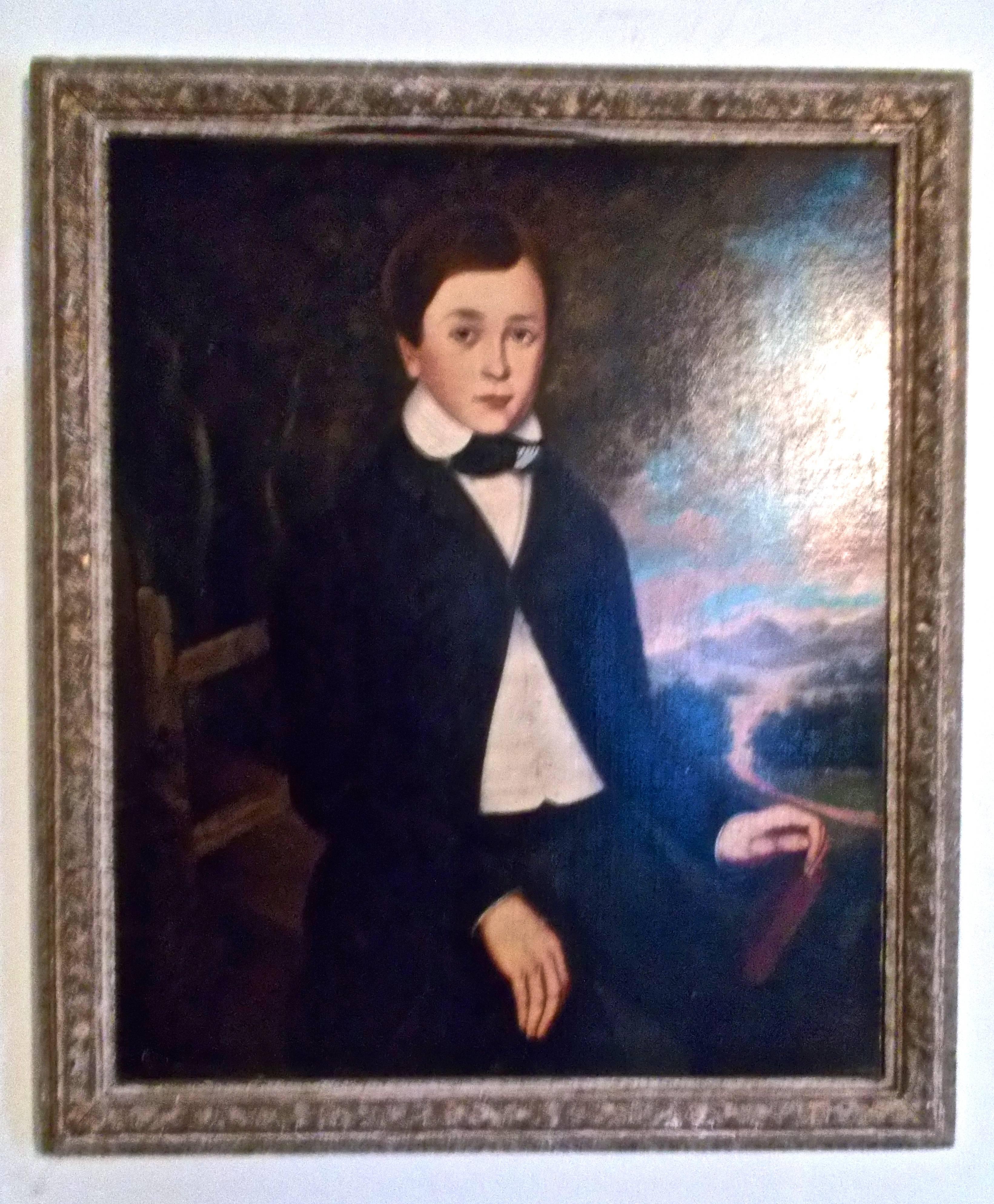 Attributed to Orlando Hands Bears, a portrait of a boy in a landscape from the great period of American folk portraiture. In a Newcomb Macklin frame (34.50 x 29.50).