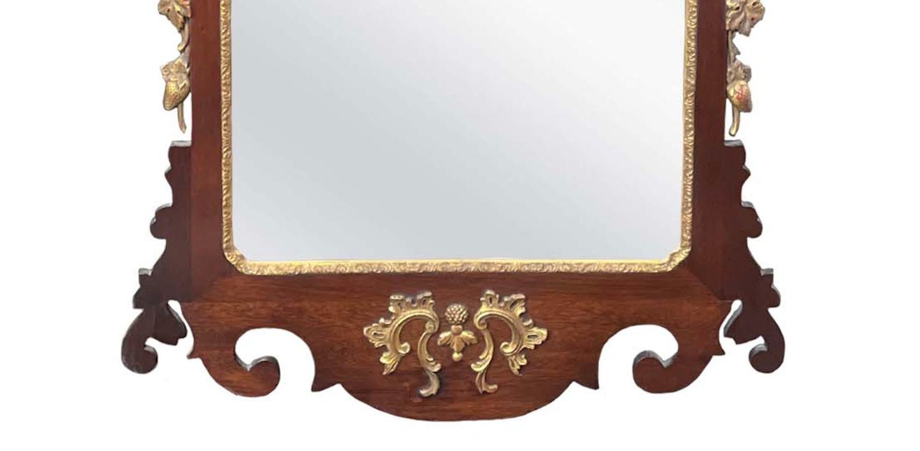 Chippendale George II style carved mahogany mirror depicting a ho-ho bird on top and strawberry stolons . American, 18th Century.
Dimensions:
48
