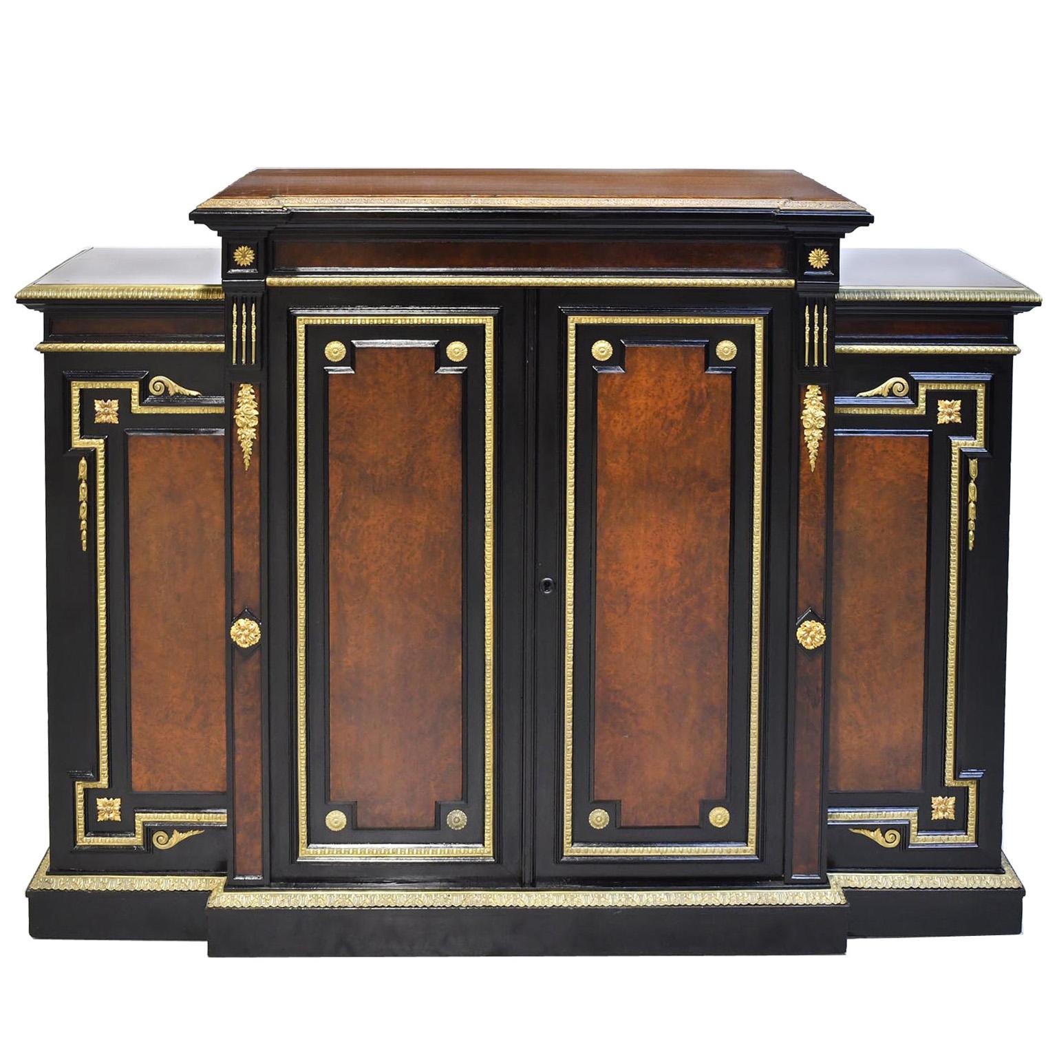 American gilded age ebonized step back credenza with burled amboyna panels and finely articulated ormolu bronze doré mounts in the manner of NY cabinet makers Ringuet-Leprince, Marcotte and Co. The exquisite doré mounts and the European half mortise