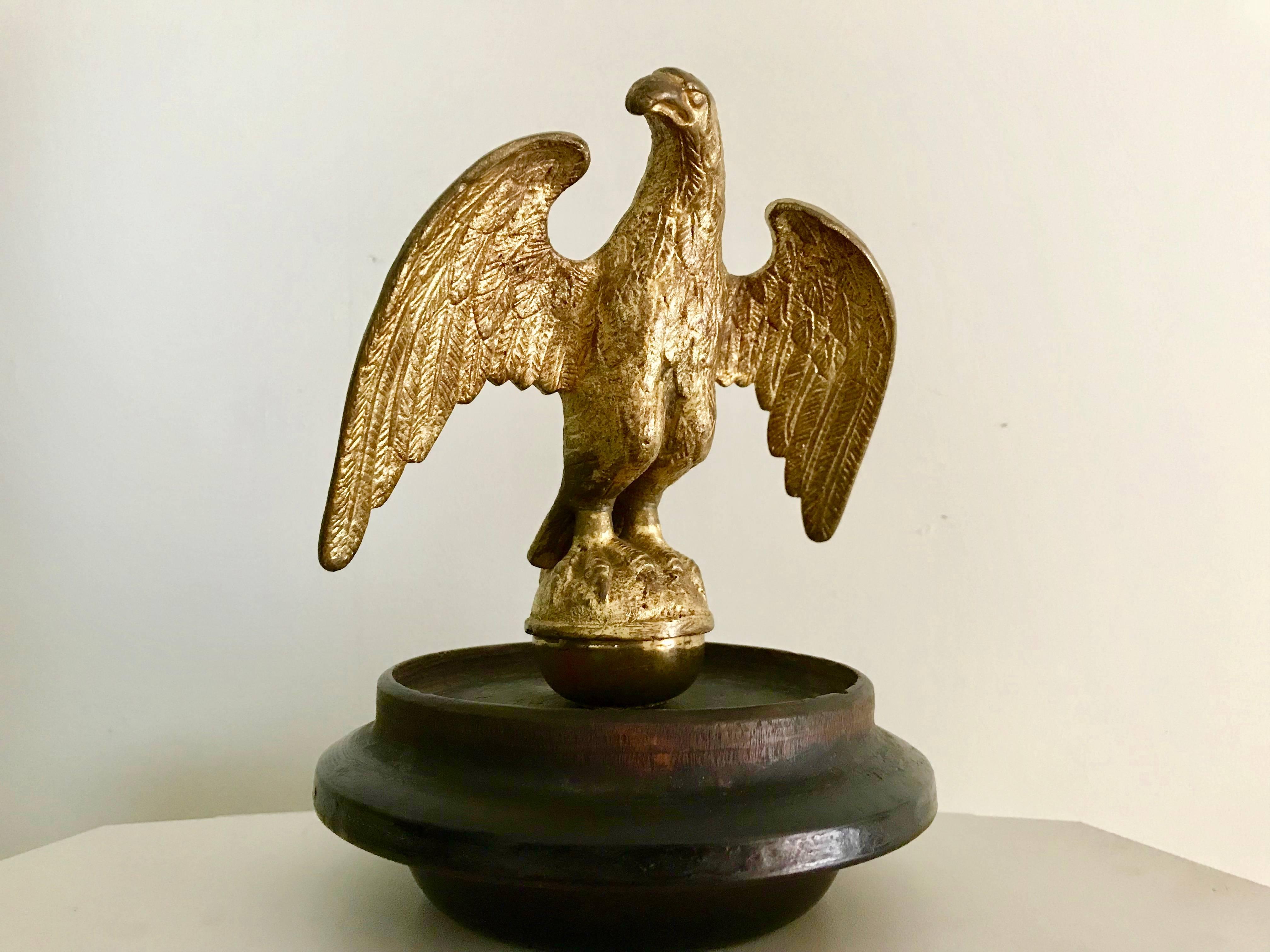 A late 19th century American gilt bronze figure of an eagle with wings unfurled shown standing on a globe or orb as if ready to take flight. Most likely this was a finial for a flag pole, the bottom of the orb is threaded for attachment. Now mounted