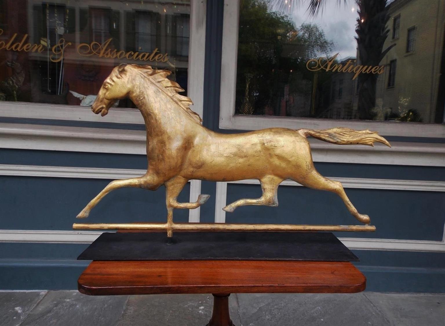 American gilt molded sheet copper full bodied running horse weathervane with the original Zinc head and mounted on a handmade iron bracket. Attributed to J.W. Fiske and Co. (ACTIVE 1870-1893), New York.
Measures: The bracket is 25.38 length / 6.63