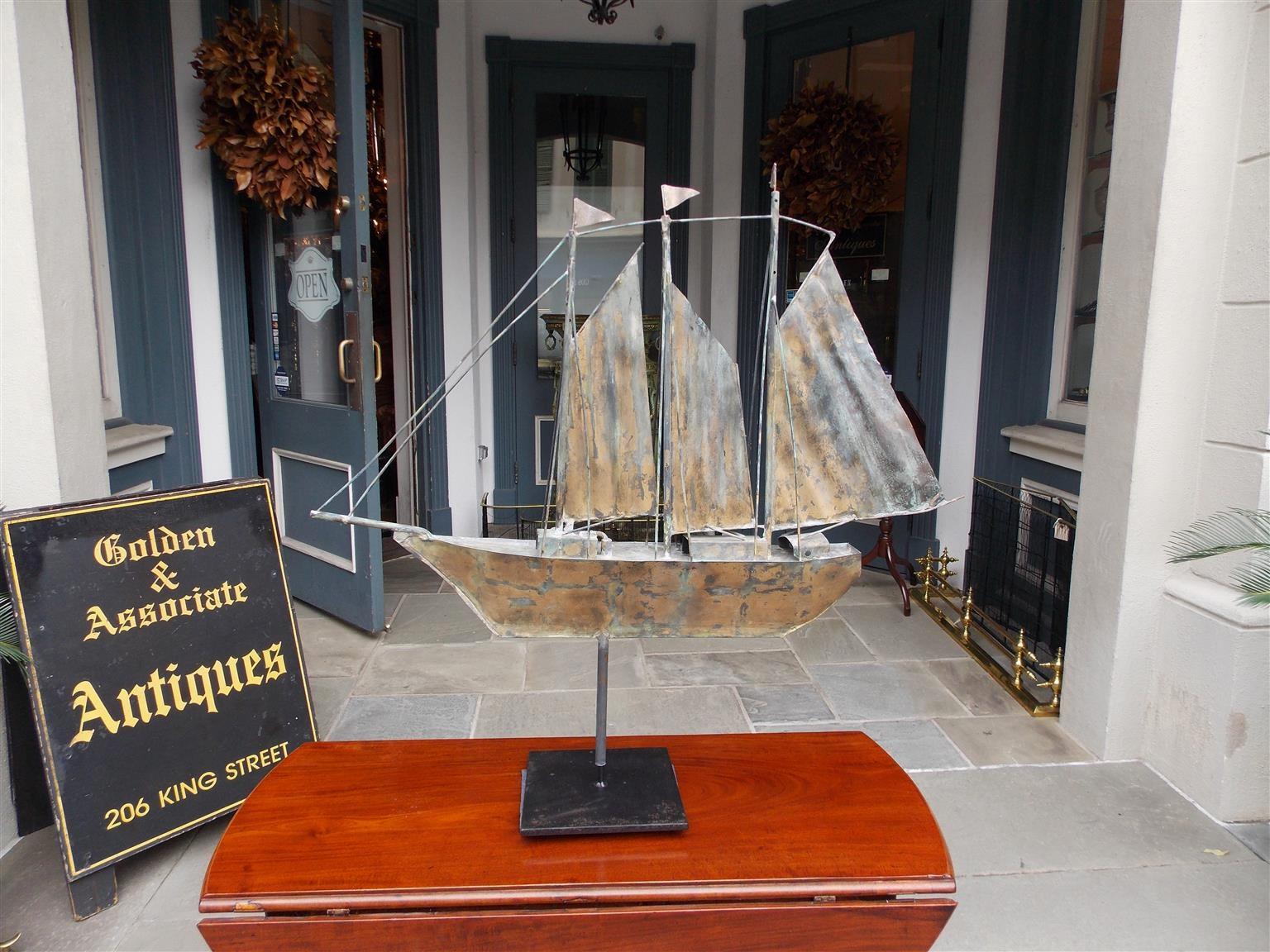 American gilt copper three masted ship weathervane with flags mounted on stand, late 19th century.
Measures: 8