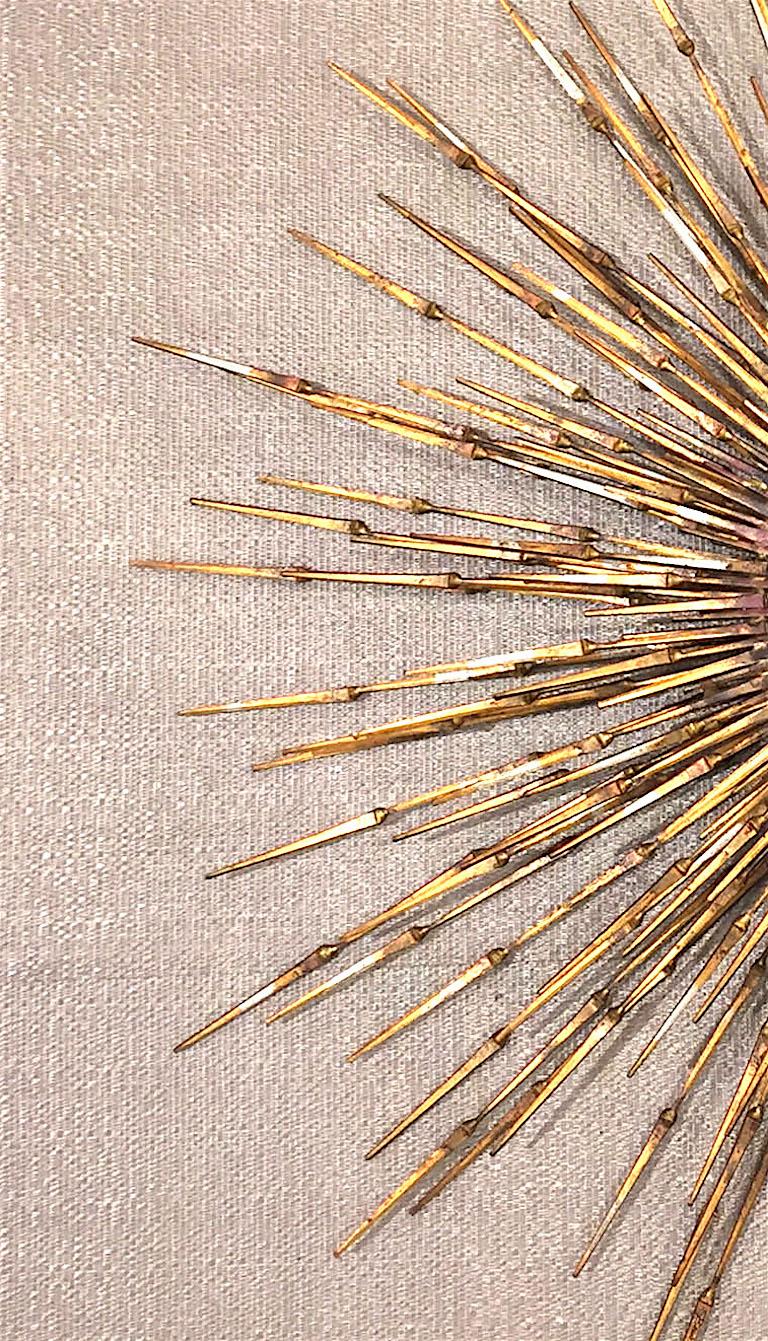 American post-war design gilt metal wall sunburst signed by William Bowie, circa 1970s.


William Bowie was a sculpture artist based in New York City from 1954 to 1994. He is best known for his works using welded gold leaf steel nails. As a