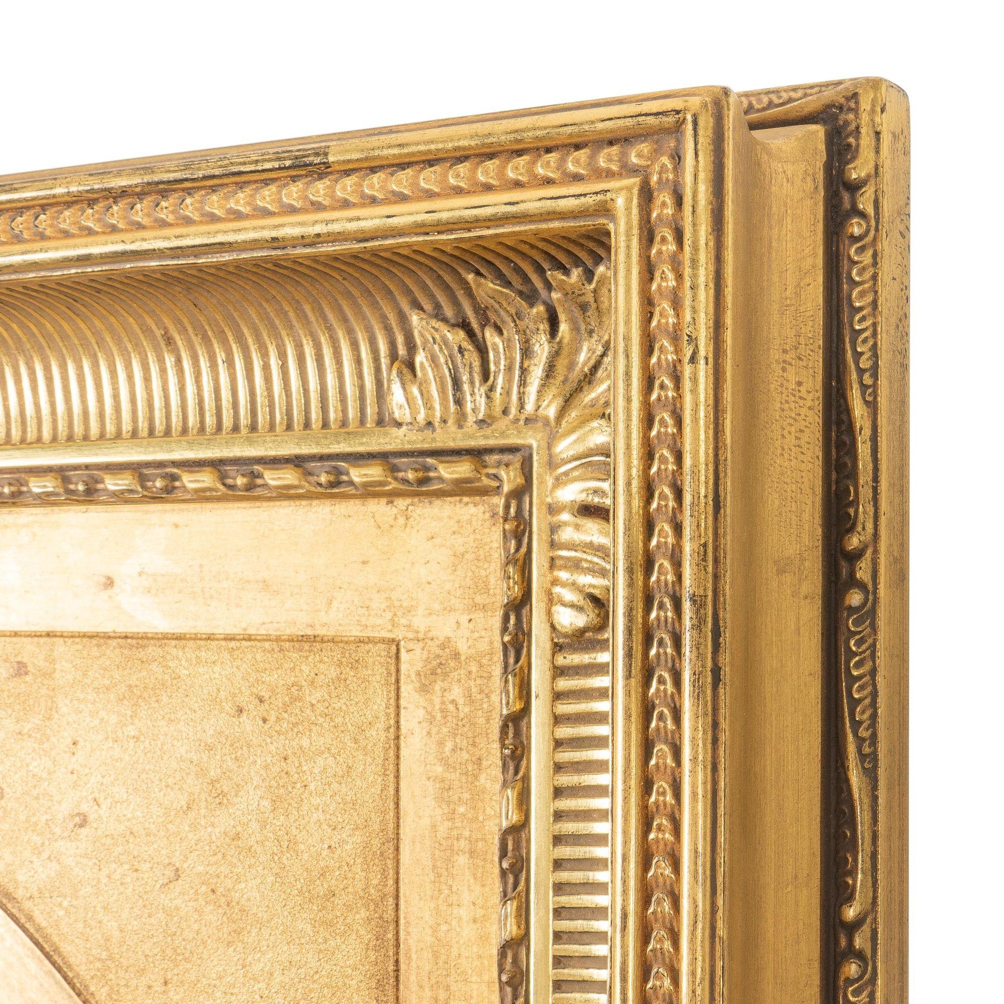 American rectangular Hudson River School style fluted cove molded picture frame has been assembled with a period gilt oval spandrel and fitted with mirrored glass. The surfaces are gilt gesso on Northern White Pine.