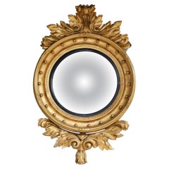Specchio da parete convesso americano in legno dorato e fogliame ebanizzato, circa 1825