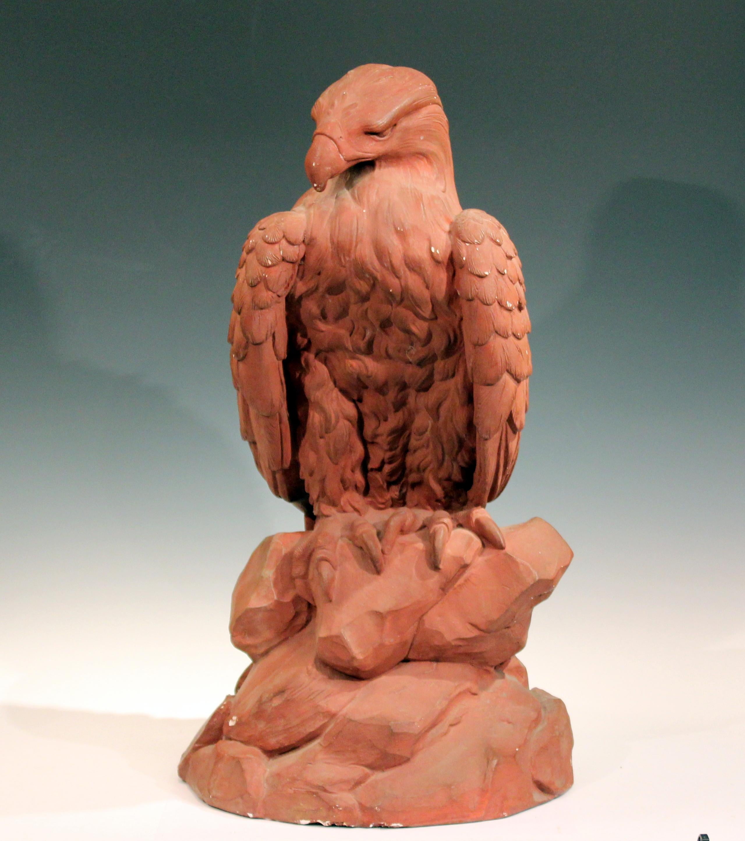 Large painted plaster eagle sculpture, circa mid-20th century. Excellent rendering of the majestic bird perched on a rock outcrop with crisp detail. Signed at lower portion. Measures: 30