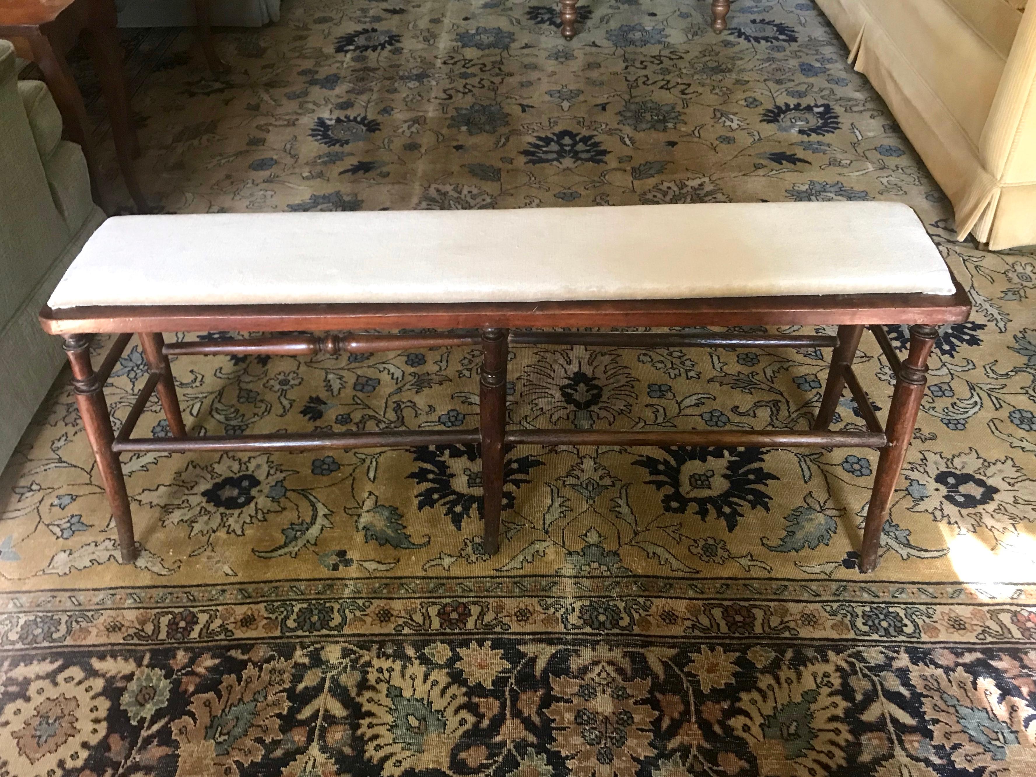 American hall bench. Rare narrow turned wood bench for hall or foot of bed with linen velvet cushion on six slightly outsplayed legs; maintaining one original turned stretcher. United States Mid-19th century. 
Dimensions: 44.5” W x 11.5” D x 18” H.