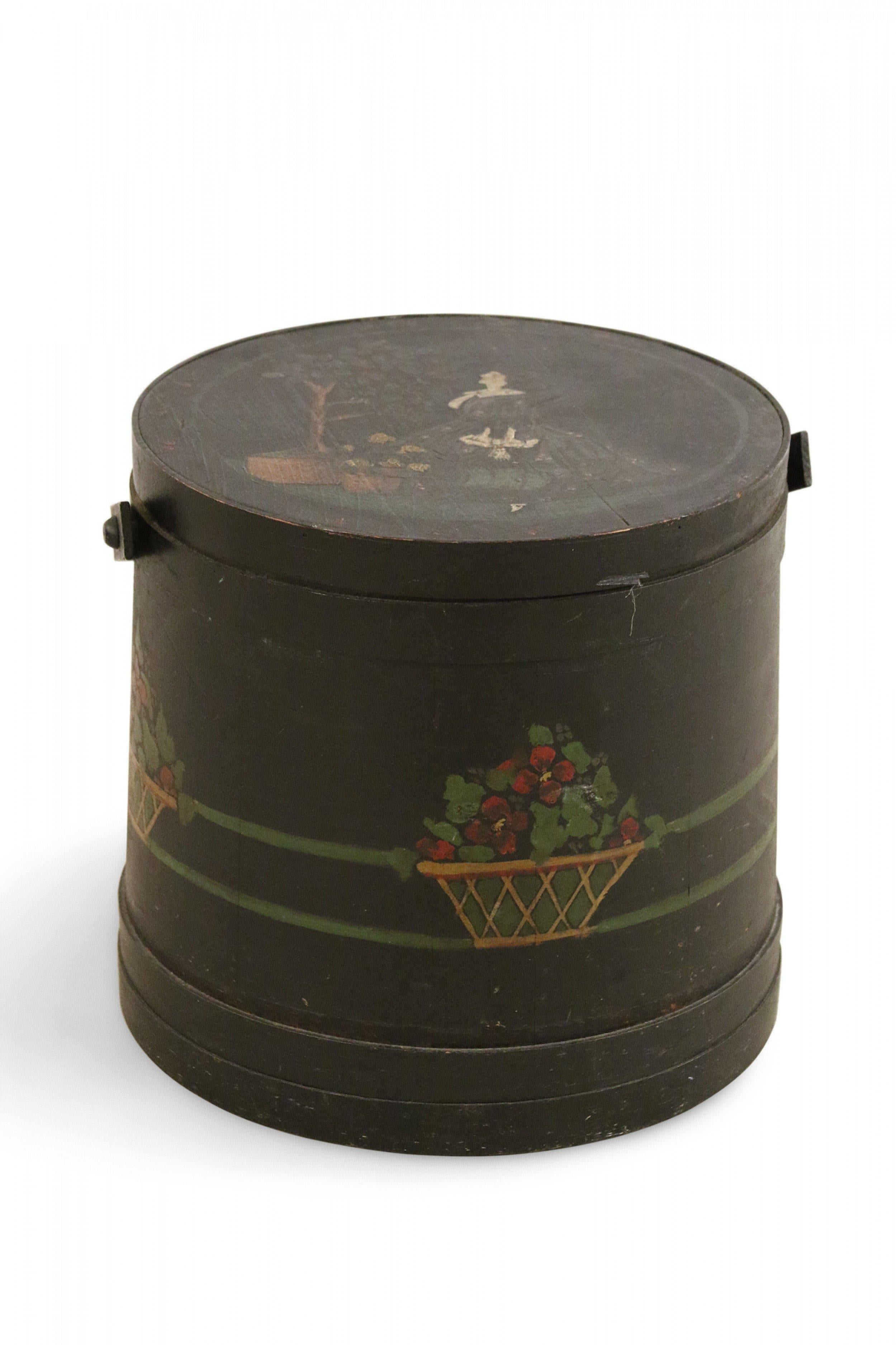 American Country banded wooden sugar bucket sewing box painted black with a blue fabric lined interior with pockets and a hand-painted genre scene of a woman watering plants on top lid. (Mayfair Toeturn).
 
