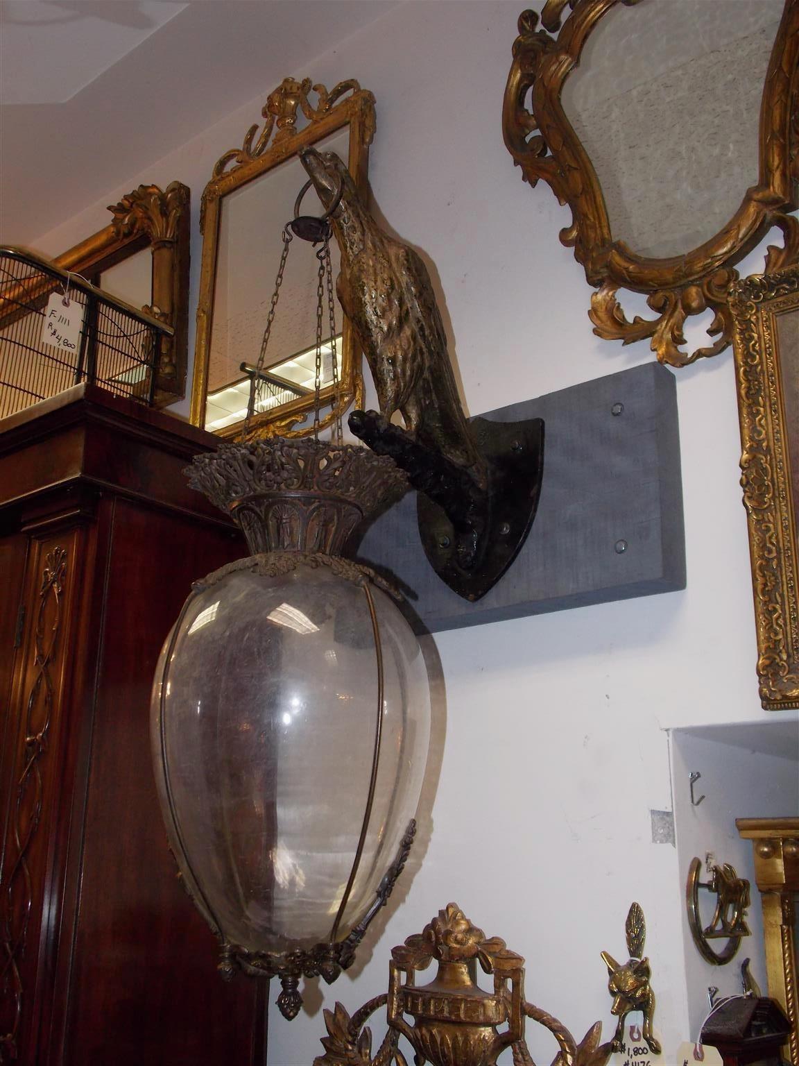 American hanging Apothecary show globe with a mounted cast iron painted and gilded eagle. Globe was filled with a colorful green or red liquid to warn a largely illiterate public of a Plaque / Corona Virus . Early 19th century.