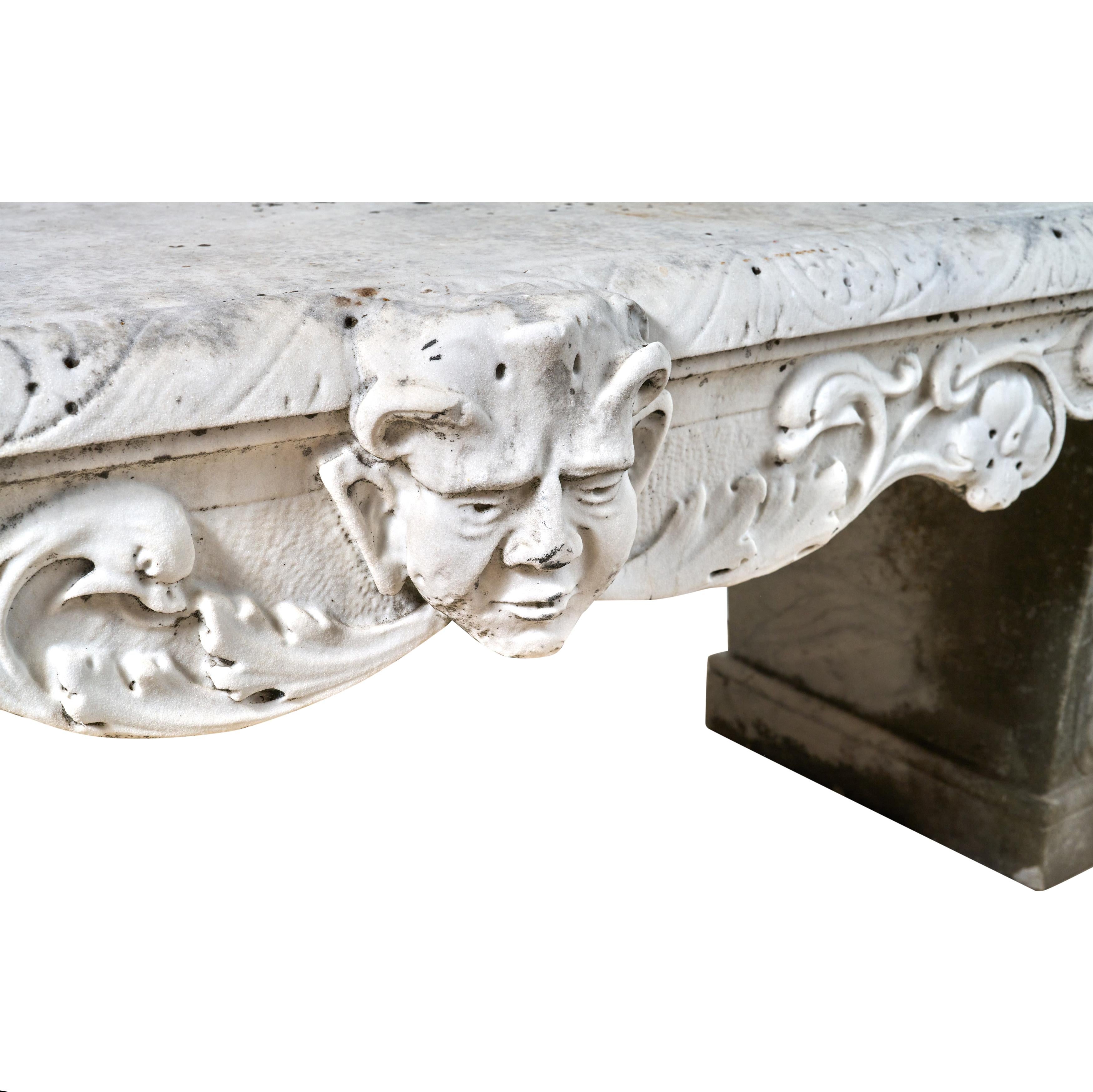Heavily carved marble bench with satyr heads. Great condition and proportions. 
