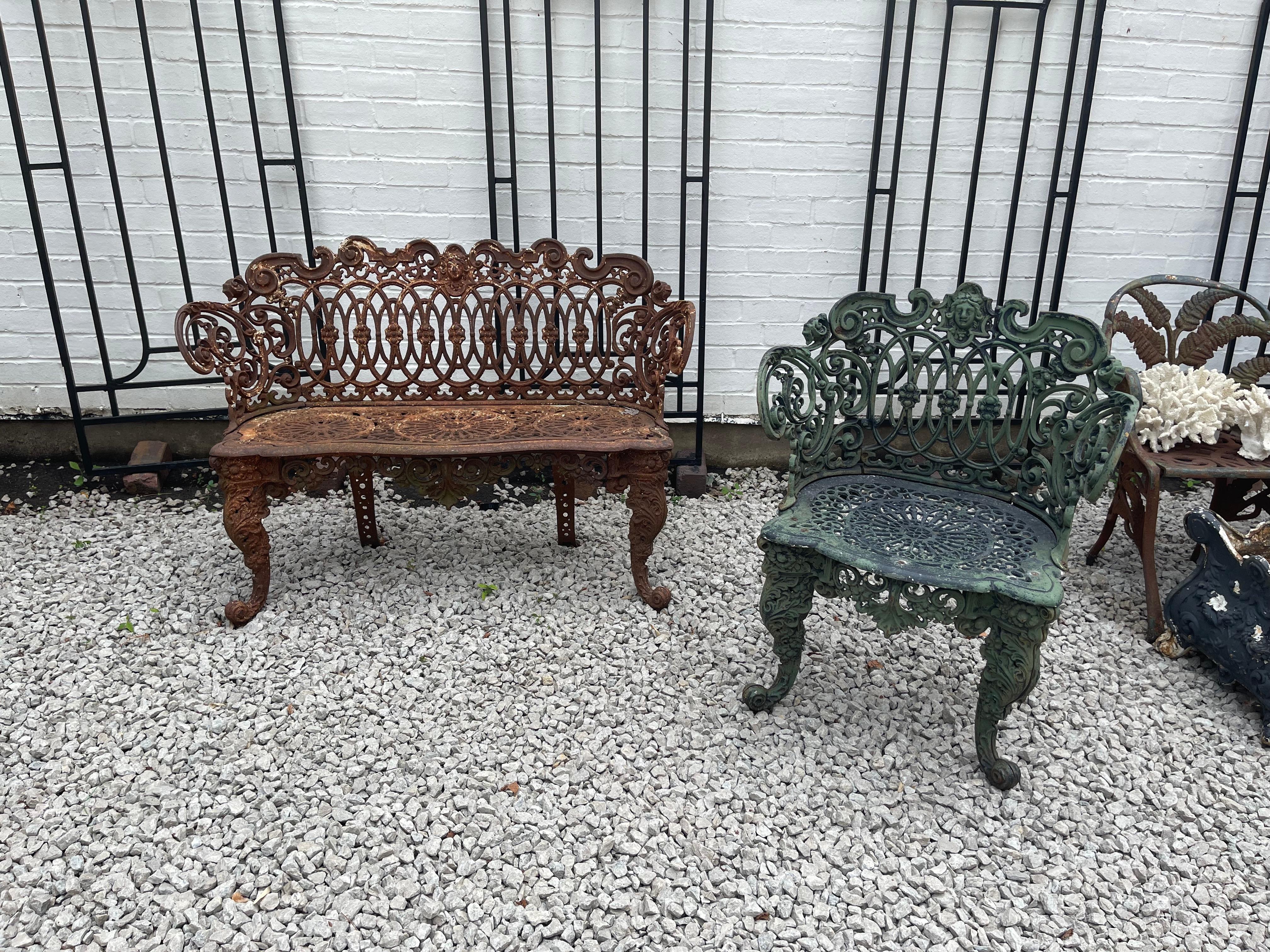 Late nineteenth century elegant American cast iron garden suite, the design is a blend is taken from the rococo revival and the Renaissance revival styles. This lot consists of settee and one chair. The seat back with continuous interlocking ovals