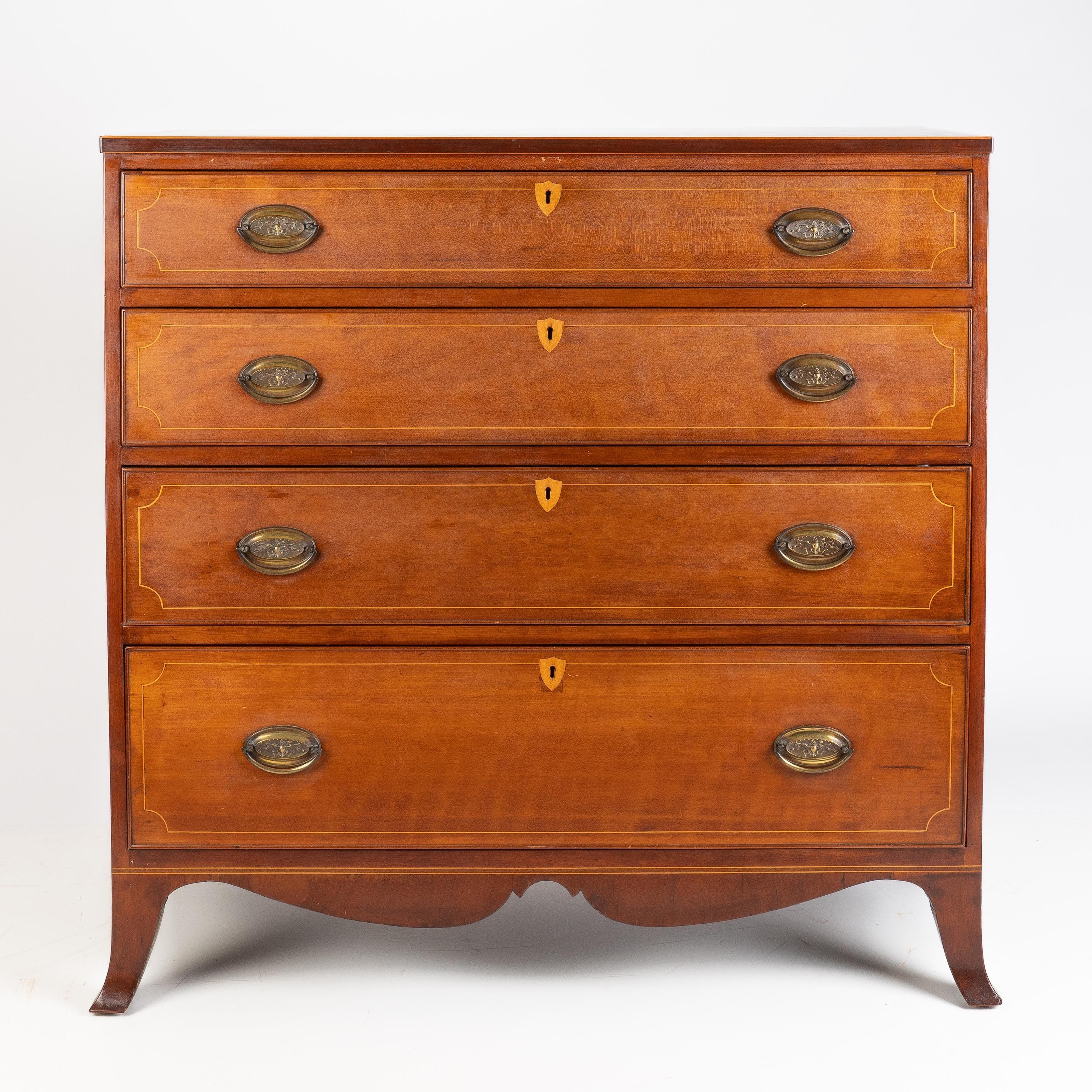 American Hepplewhite cherry chest on French bracket feet joined by a scolloped apron. The four drawer fronts are figured cherry inlaid with holy stringing and framed by a cock bead molding. The key escutcheons are defined by shield inlays of a light
