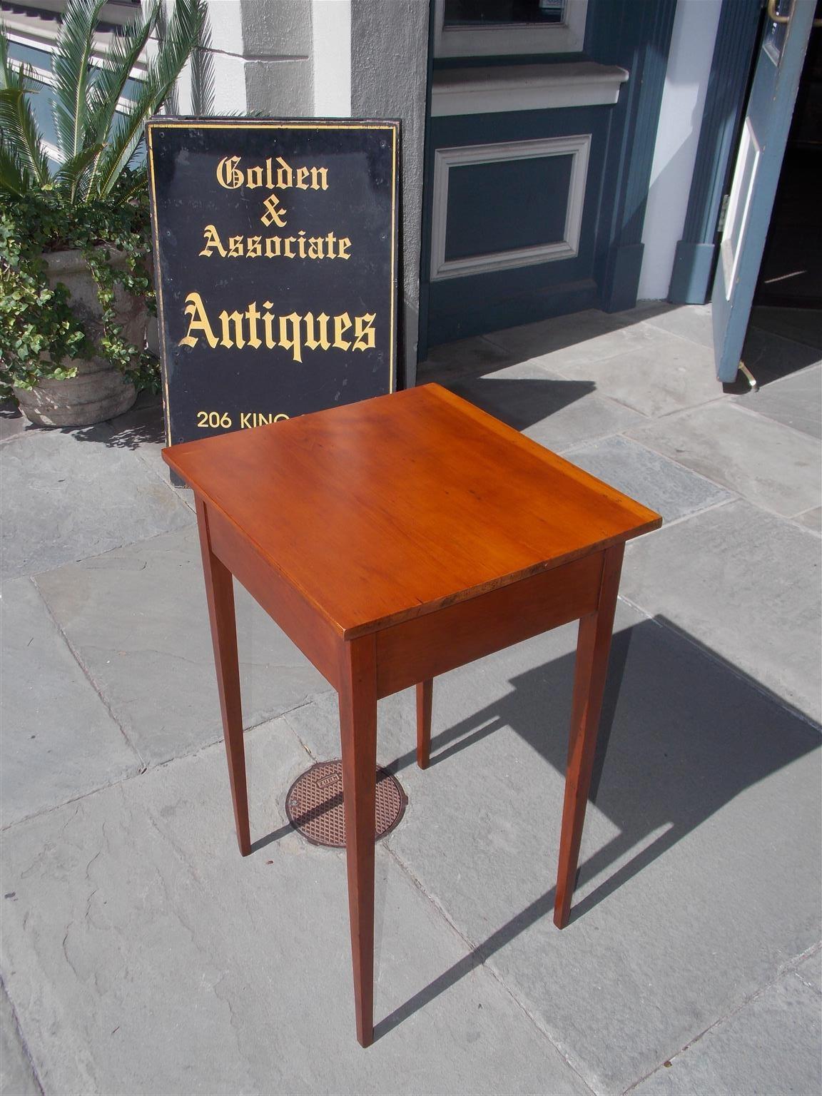 American Hepplewhite cherry stand with a straight edge top , skirt panels and terminating on the original squared tapered legs, Early 19th century.