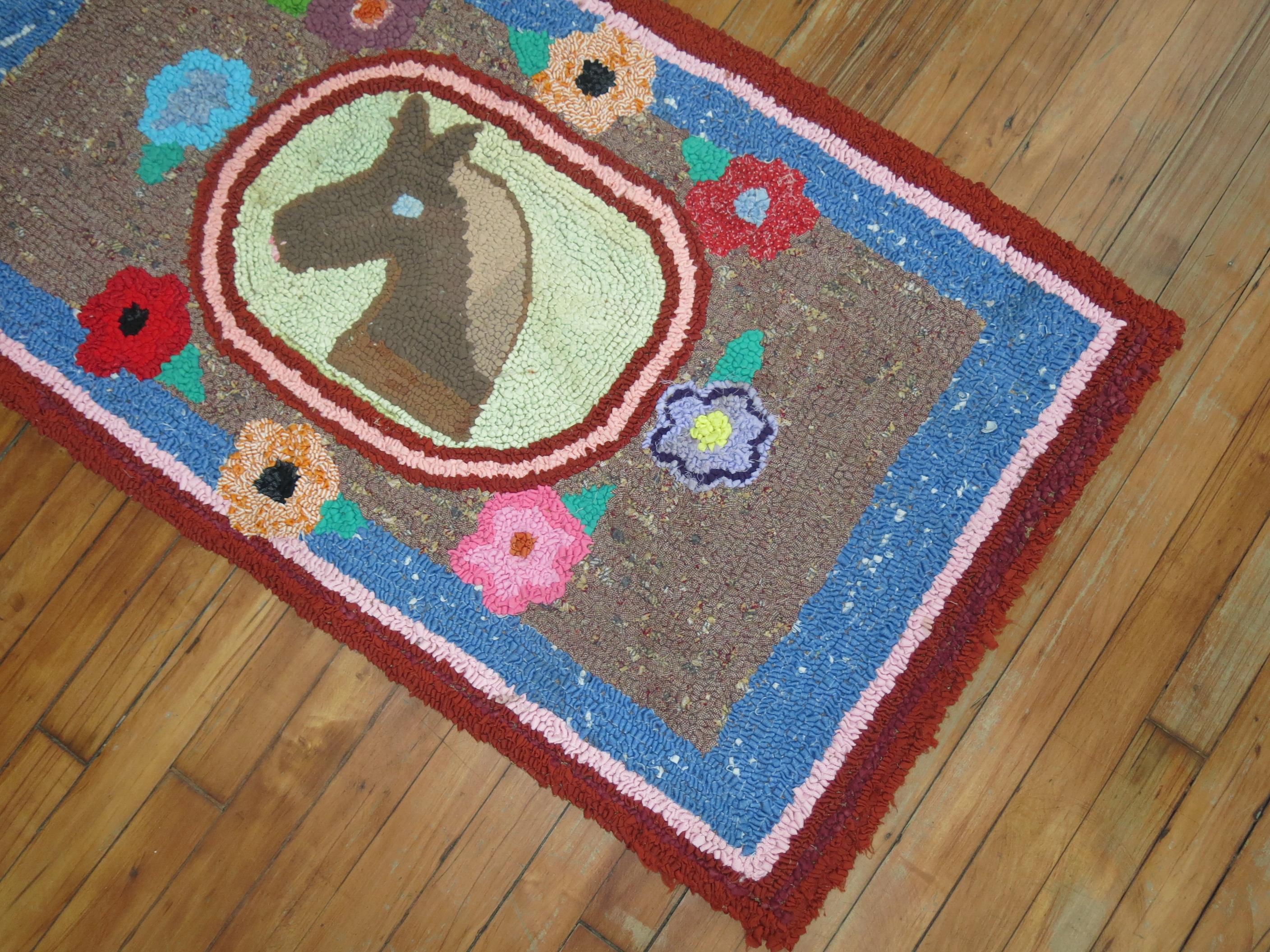 A handmade American Hooked rug from the early part of the 20th century depicting a horses face surrounded by flowers. No stains, no tears, has been professionally cleaned. Backed with blue fabric.