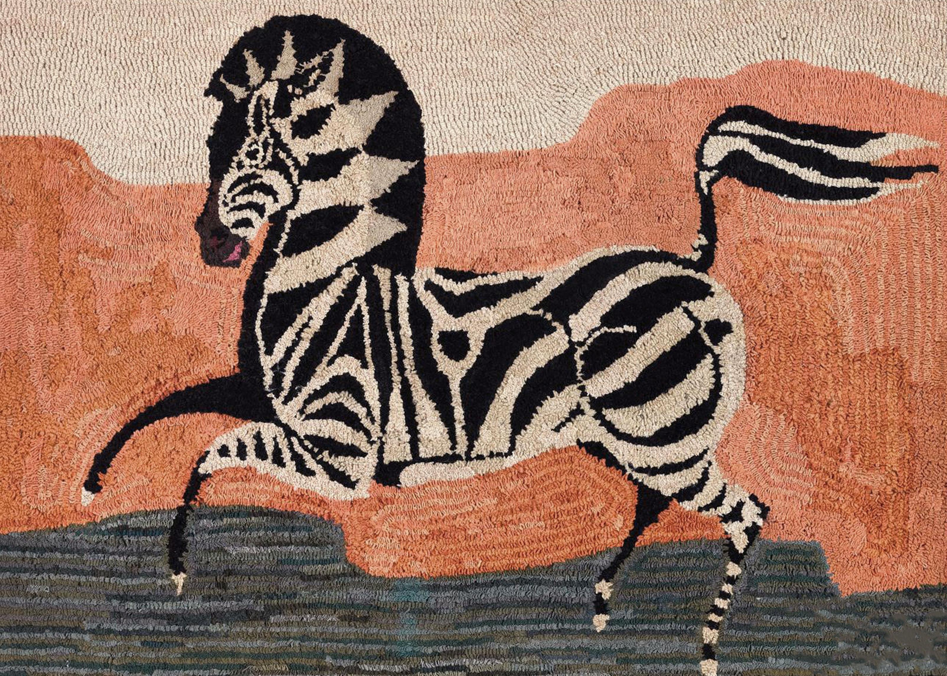 American Hooked rug Depicting a Zebra
early 20th century,

Dramatic American Folk Art hooked rug of a prancing Zebra depicted against bands of color-cream, orange, and a lower band of green grass. 

Mounted on black fabric covered
