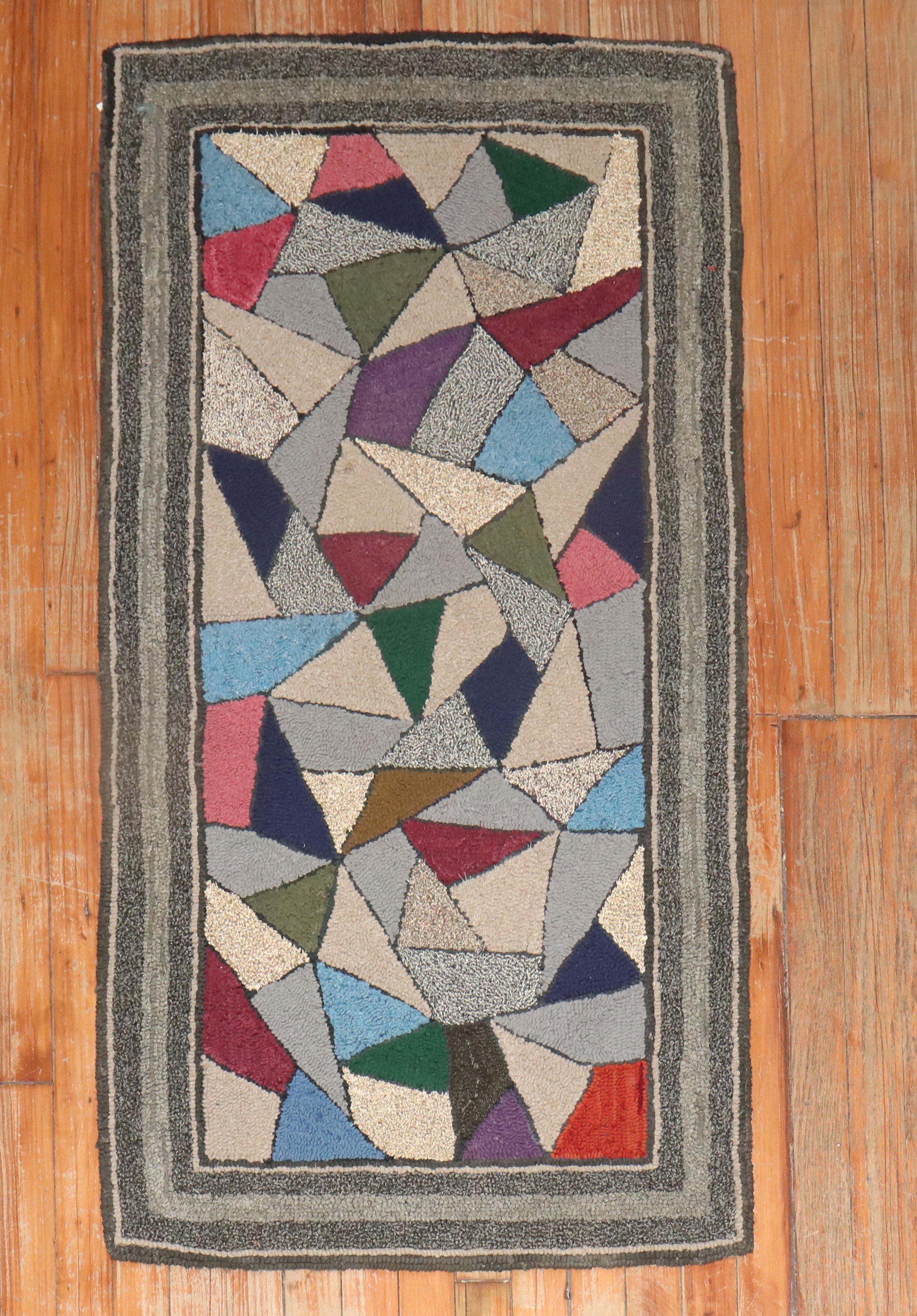 A handmade decorative American hooked scatter size rug from the middle of the 20th century 

Measures: 2'2