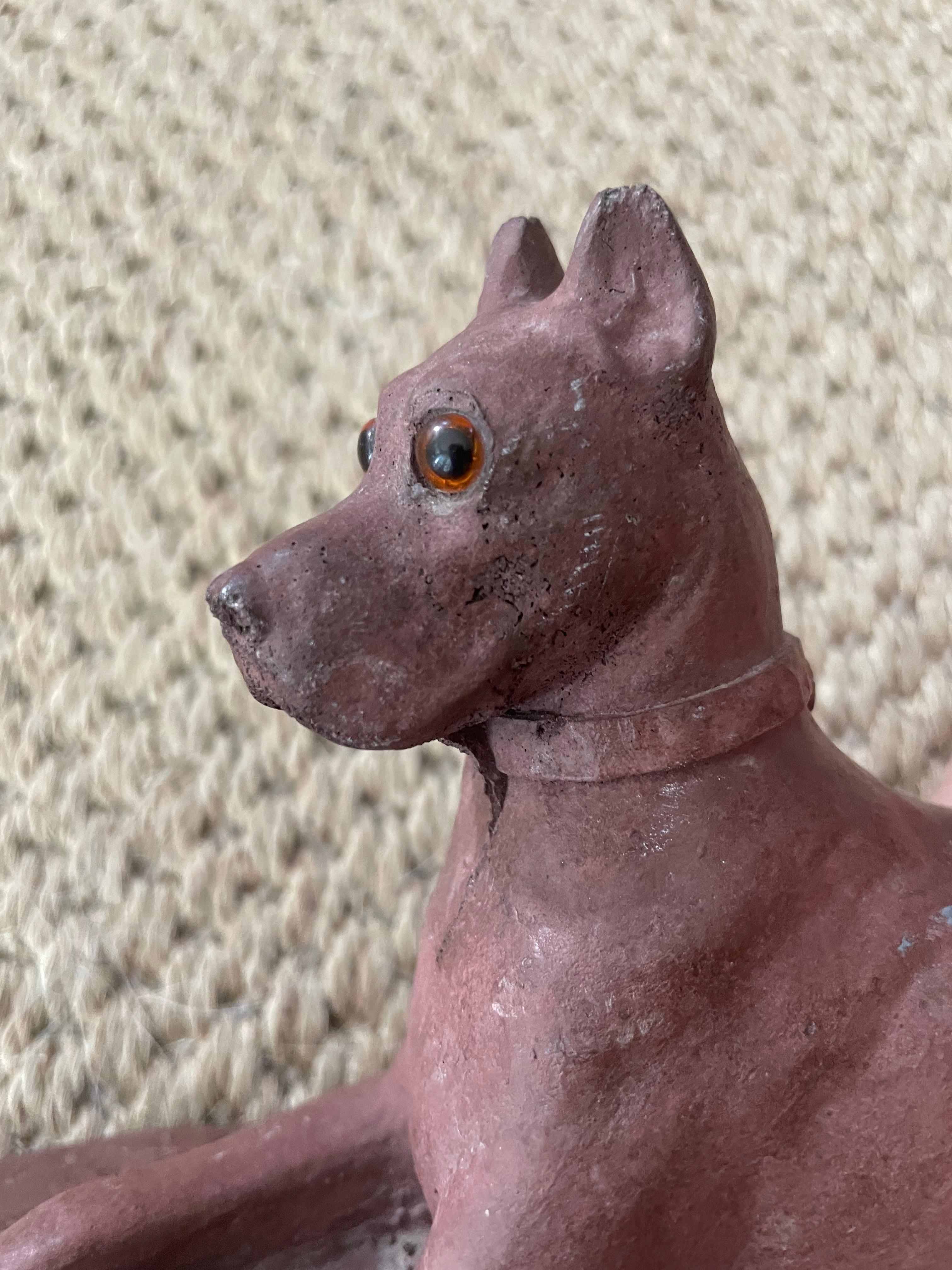 American hound sculpture. Red clay fired recumbent Great Dane with glass eyes. United States, 20th century
Dimensions: 9” W x 3.38” D x 5” H 