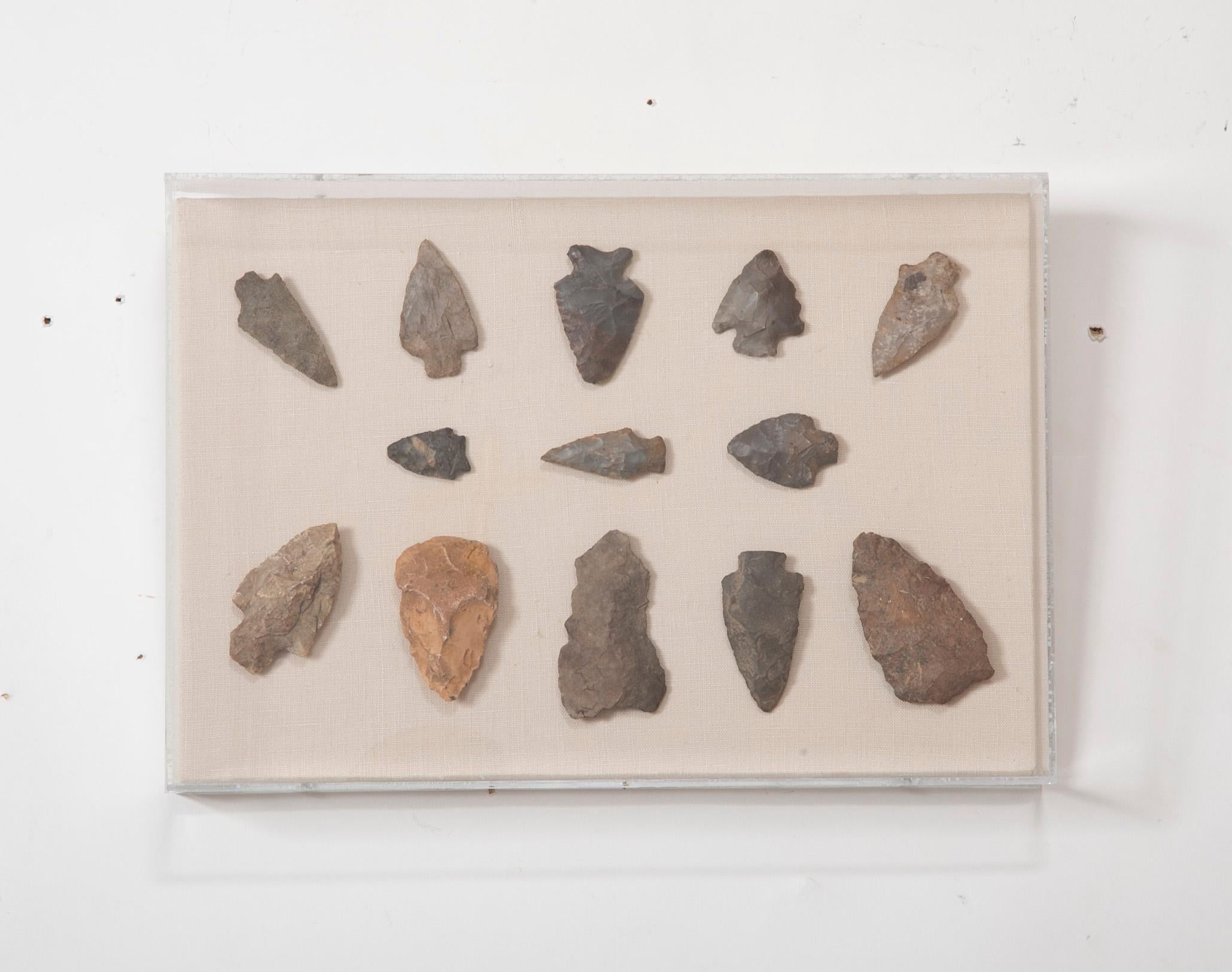 Set of four framed collection of early American Indian hand-hewn stone arrowheads from various Western states. These historical artifacts have been beautifully framed in plexiglass boxes, showing the detail of the surface and subtlety of color. A