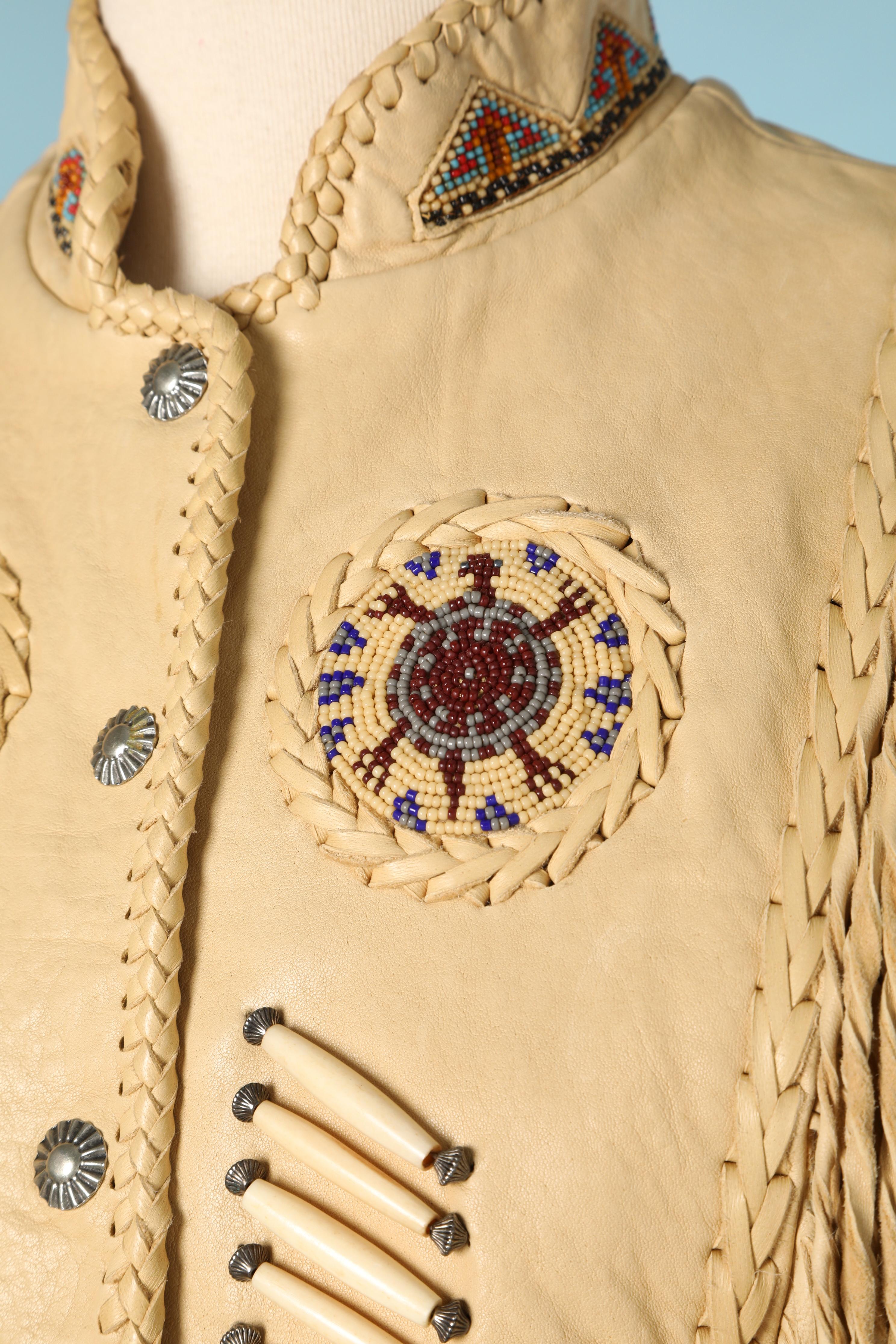 American Indian leather vest with beaded work and fringes.
Acetate lining. Metallic snap
SIZE 6